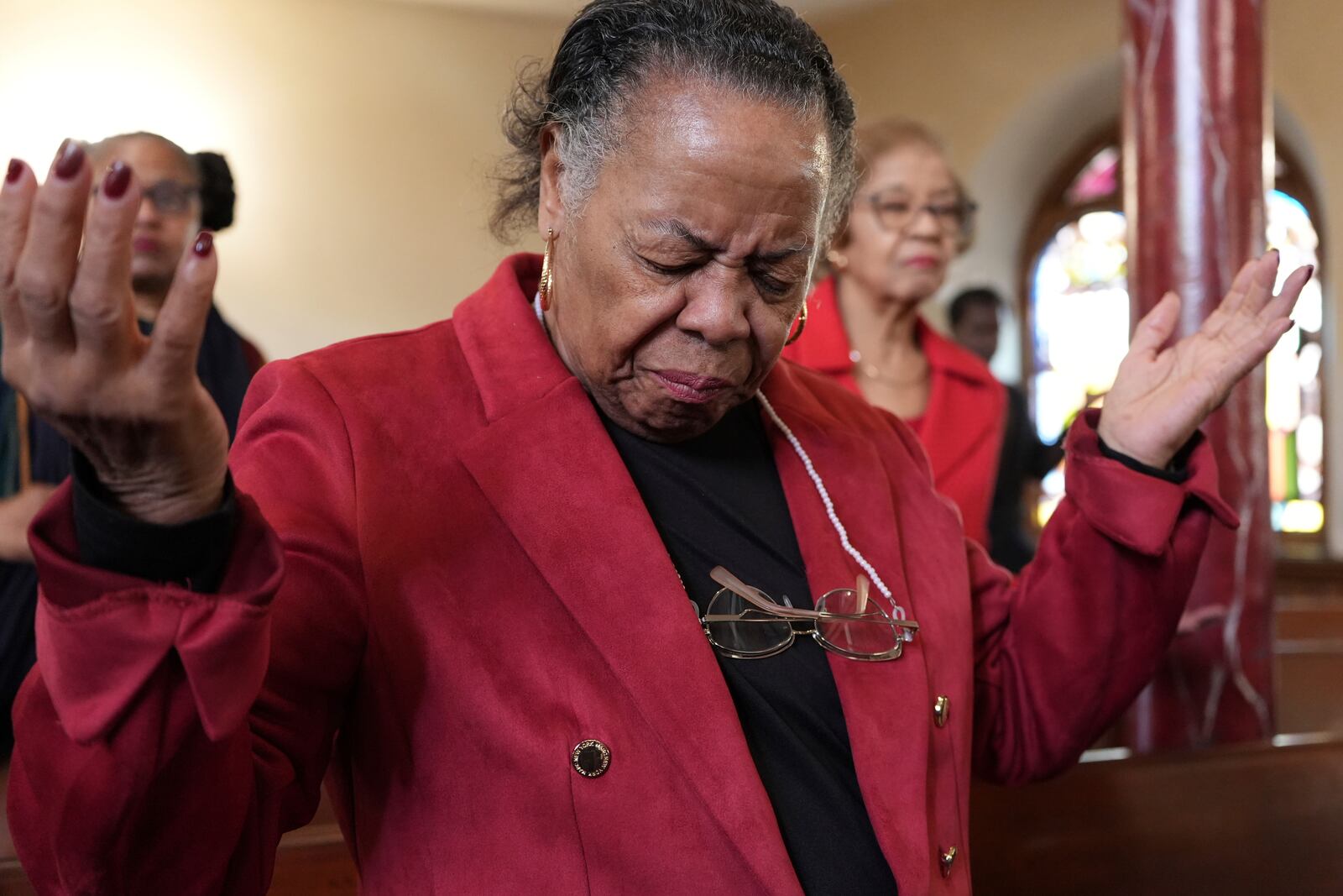 FILE - A congregant at Mother Bethel AME Church prays during a service in Philadelphia, Oct. 13, 2024. (AP Photo/Luis Andres Henao, File)