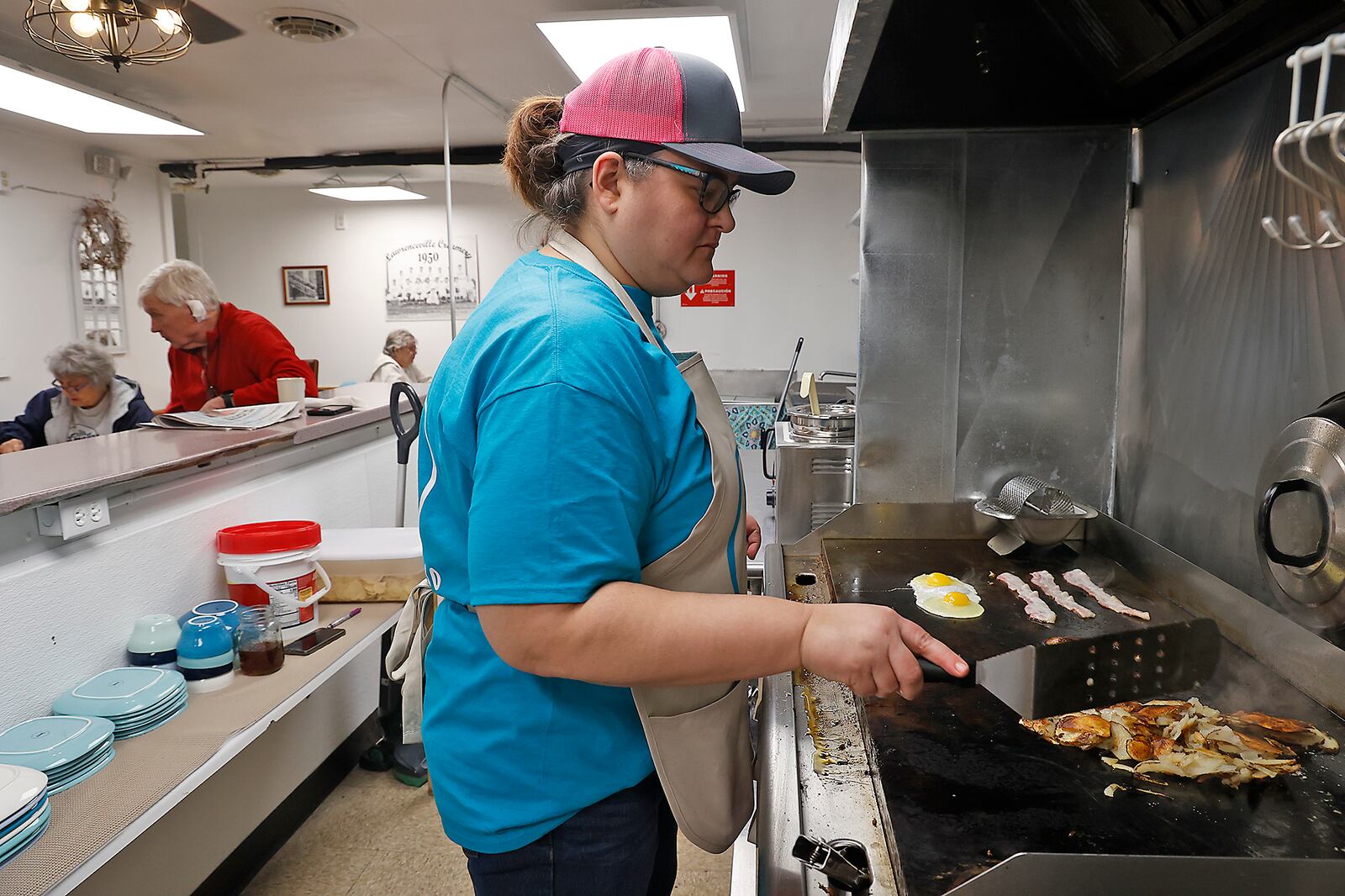 Erin Phillips, the owner and cook at Vittles & Grits, works on a breakfast order Monday, Jan. 30, 2023. BILL LACKEY/STAFF