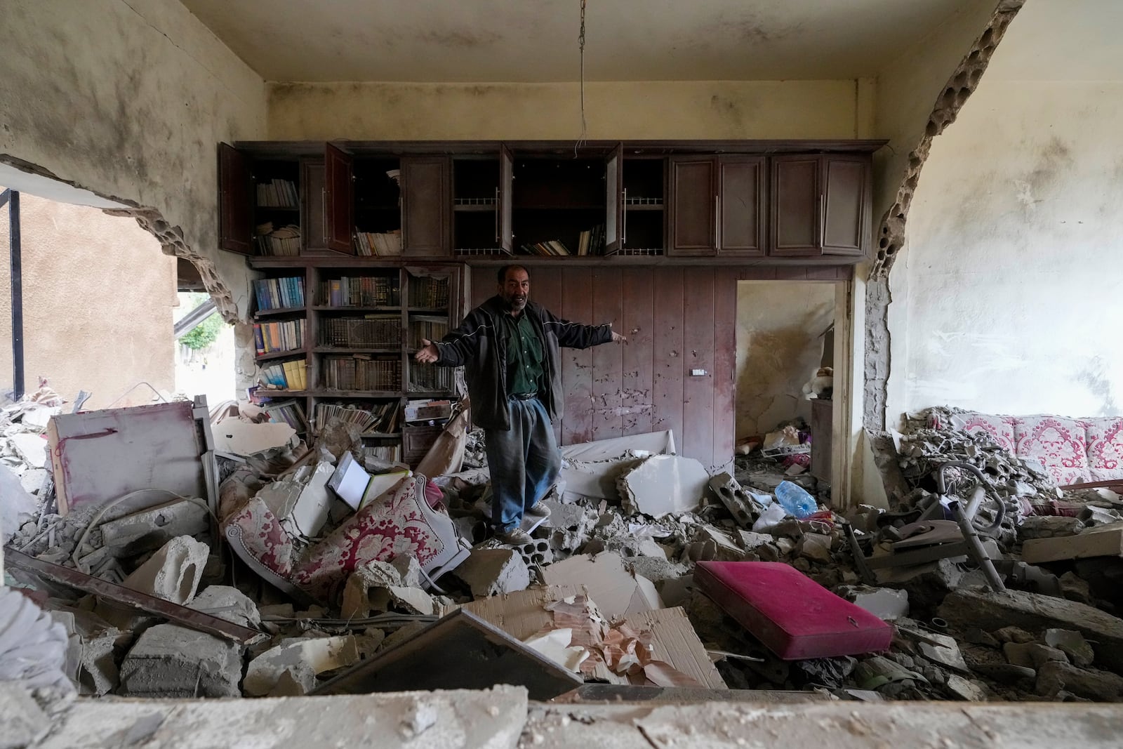 A man inspects a house that was destroyed in Israeli airstrikes in Baalbek, eastern Lebanon, Thursday, Nov. 28, 2024. (AP Photo/Hassan Ammar)