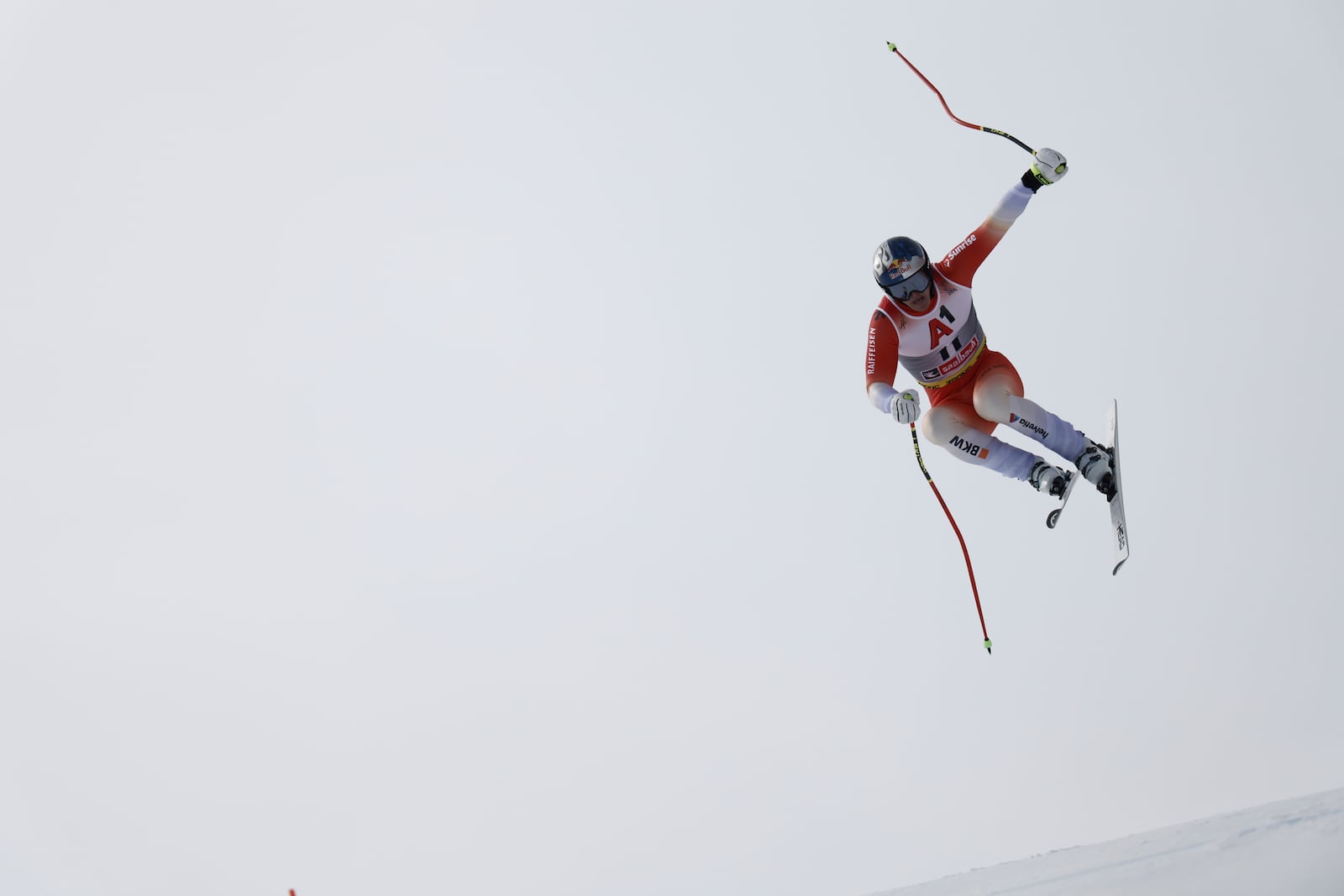 Switzerland's Franjo von Allmen is airborne during a men's downhill race, at the Alpine Ski World Championships, in Saalbach-Hinterglemm, Austria, Sunday, Feb. 9, 2025. (AP Photo/Gabriele Facciotti)