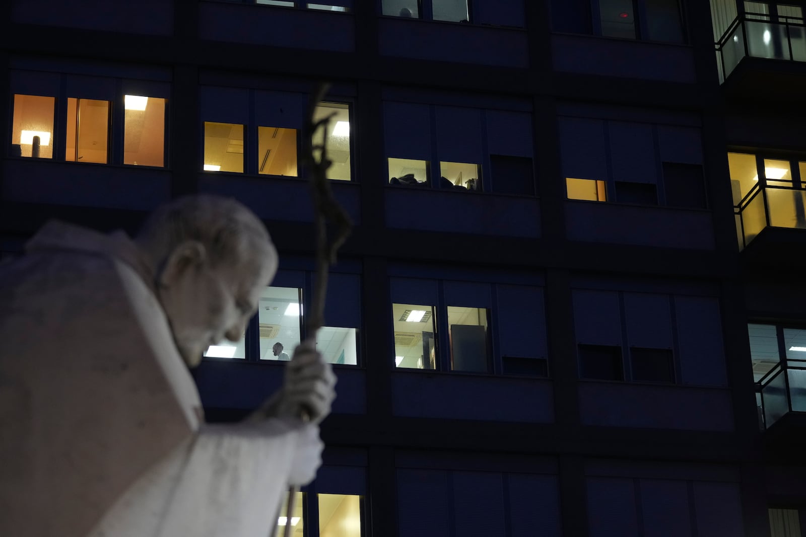 A statue of Pope John Paul II is seen in front of the Agostino Gemelli Polyclinic, Rome, Wednesday, Feb. 19, 2025, where the Pontiff is hospitalized since Friday, Feb. 14. (AP Photo/Andrew Medichini)