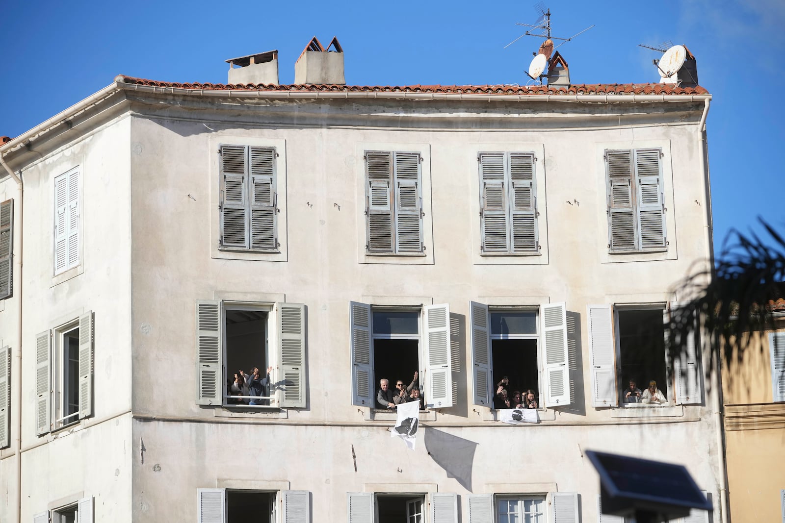 Faithful wait for the arrival of Pope Francis in Ajaccio on the occasion of his one-day visit in the French island of Corsica, Sunday, Dec. 15, 2024. (AP Photo/Alessandra Tarantino)