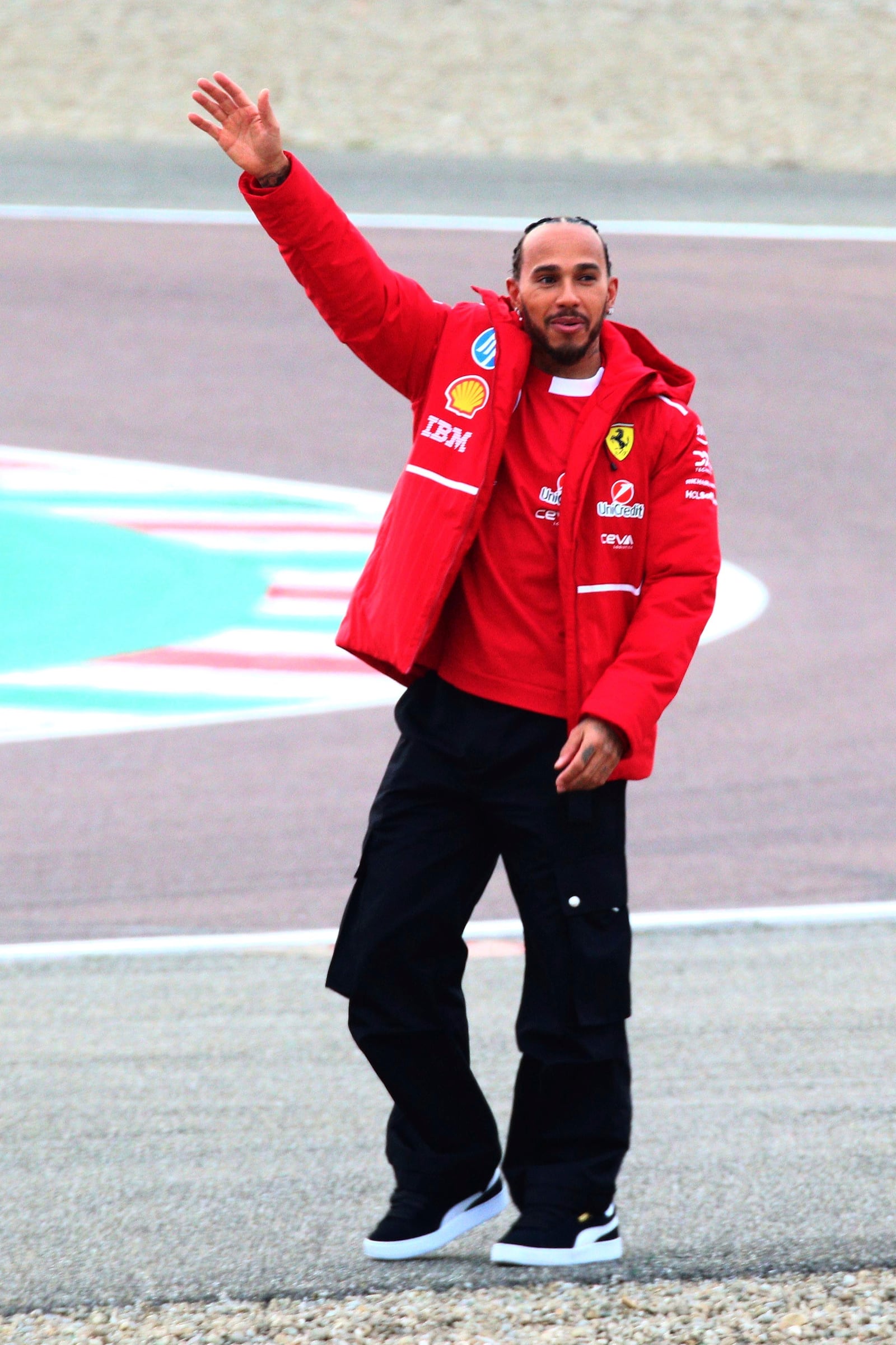 Ferrari driver Lewis Hamilton waves to fans after testing the new Ferrari SF-25 at Fiorano circuit, near Maranello, Italy, Wednesday Feb. 19, 2025. (Davide Gennari/LaPresse via AP)