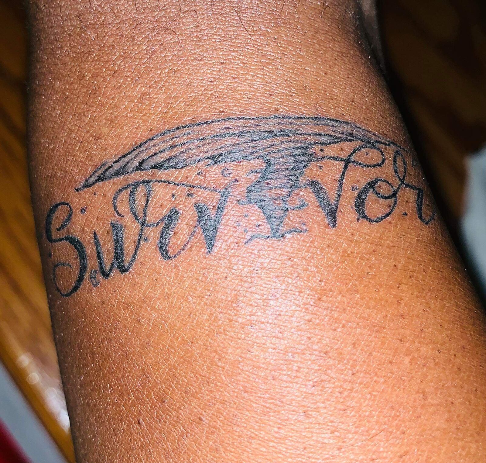 Kory Middlebrooks of Dramatik Ink recently tattooed Survivor on Trotwood resident Kelly Watts wrist with a tornado.