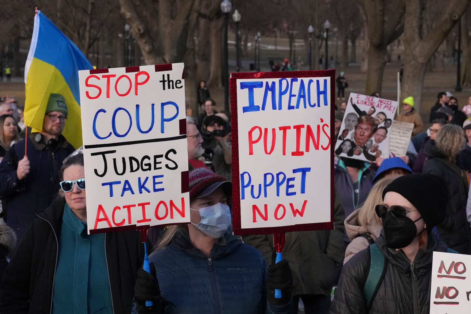 People protest on Boston Common, Tuesday, March 4, 2025, in Boston. (AP Photo/Charles Krupa)