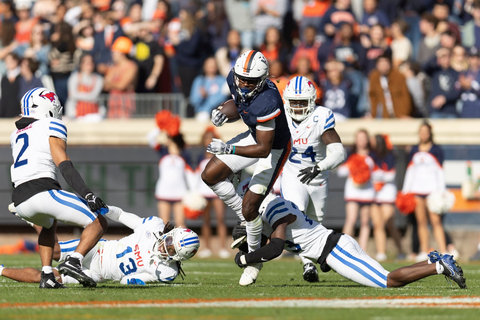 Virginia wide receiver Malachi Fields (8) is tackled by Southern Methodist safety Isaiah Nwokobia (23) during the first half of an NCAA college football game, Saturday, Nov. 23, 2024, in Charlottesville, Va. (AP Photo/Mike Kropf)