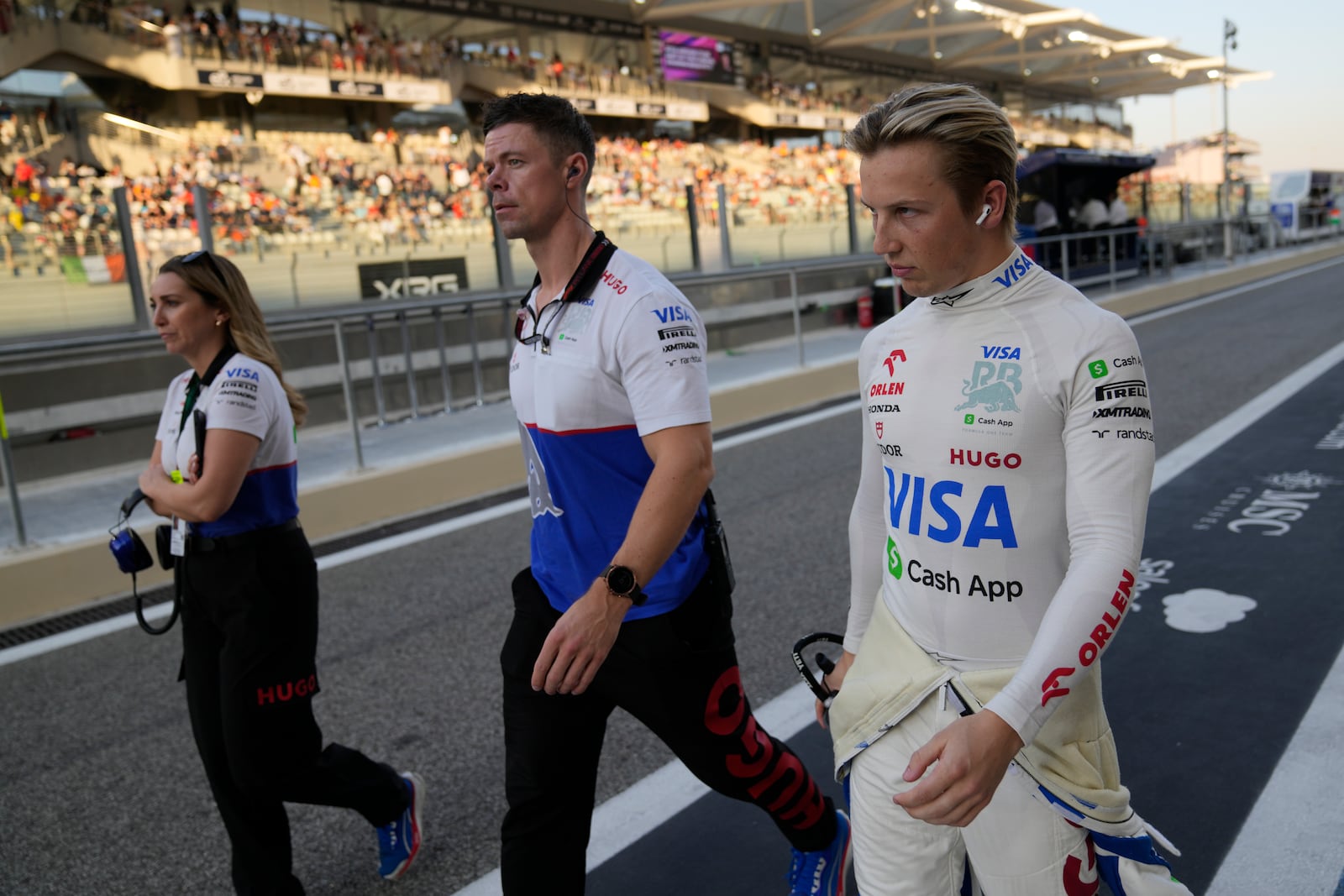 RB driver Liam Lawson of New Zealand walks in the pit lane before the Formula One Abu Dhabi Grand Prix at the Yas Marina Circuit in Abu Dhabi, UAE, Sunday, Dec. 8, 2024. (AP Photo/Darko Bandic)