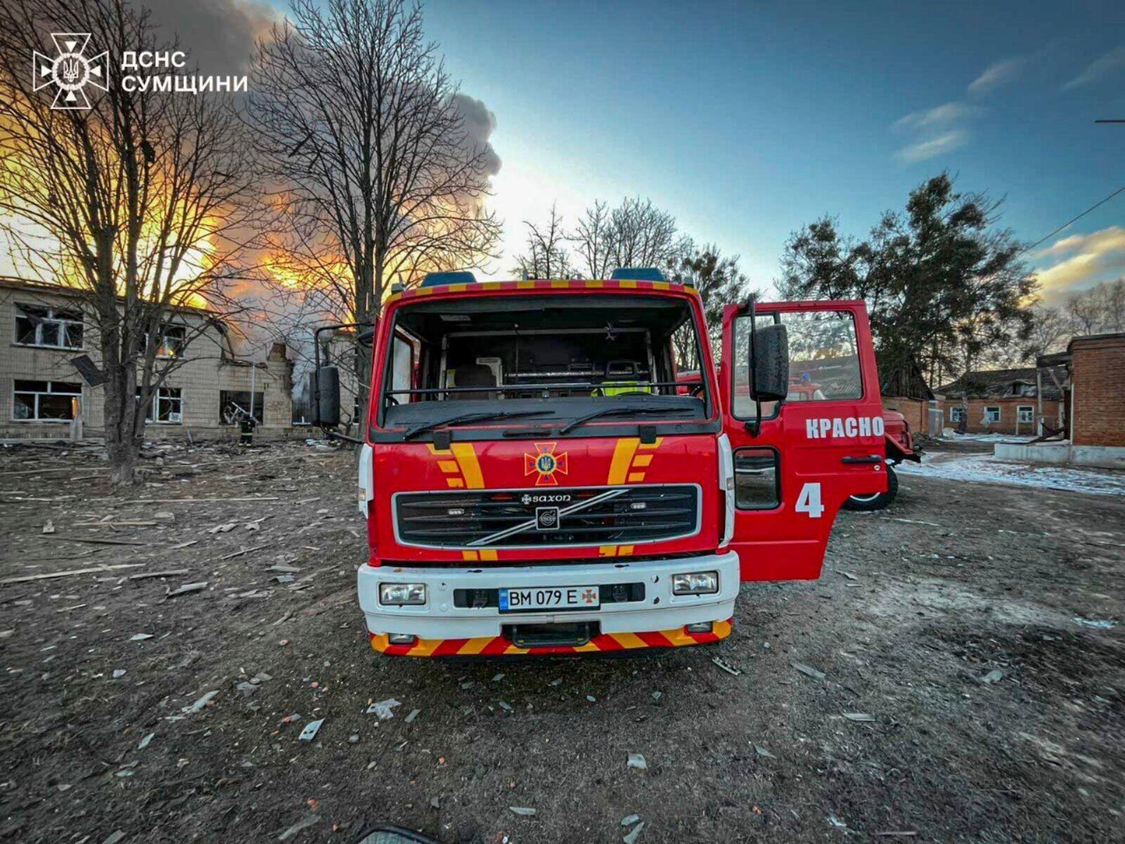 In this photo provided by the Ukrainian Emergency Service on Wednesday, March 19, 2025, firefighters' truck is parked on a site of a Russian attack in Krasnopillia, Sumy region, Ukraine. (Ukrainian Emergency Service via AP)