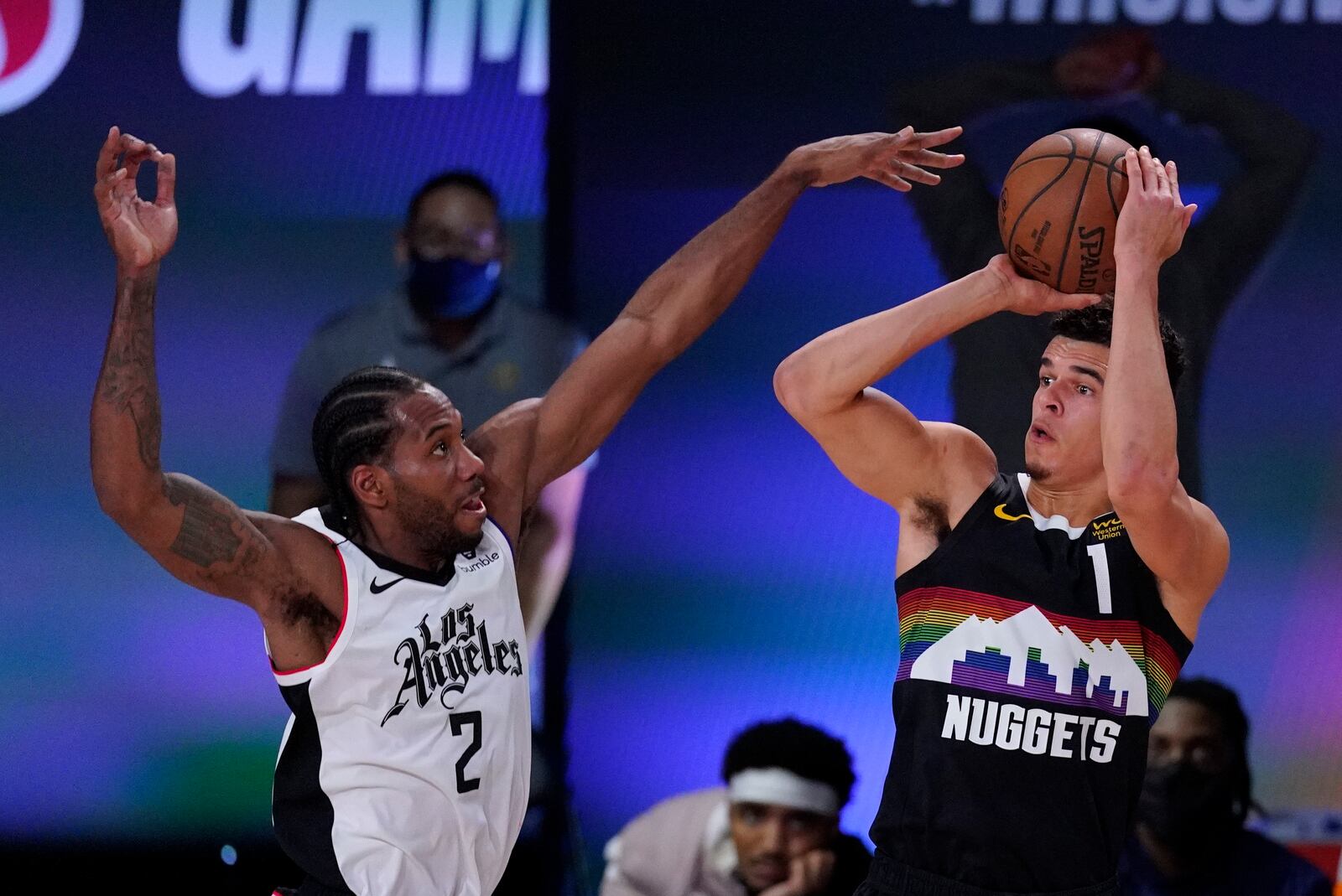 Denver Nuggets' Michael Porter Jr. (1) shoots abasing Los Angeles Clippers' Kawhi Leonard (2) during the first half of an NBA conference semifinal playoff basketball game, Wednesday, Sept. 9, 2020, in Lake Buena Vista, Fla. (AP Photo/Mark J. Terrill)