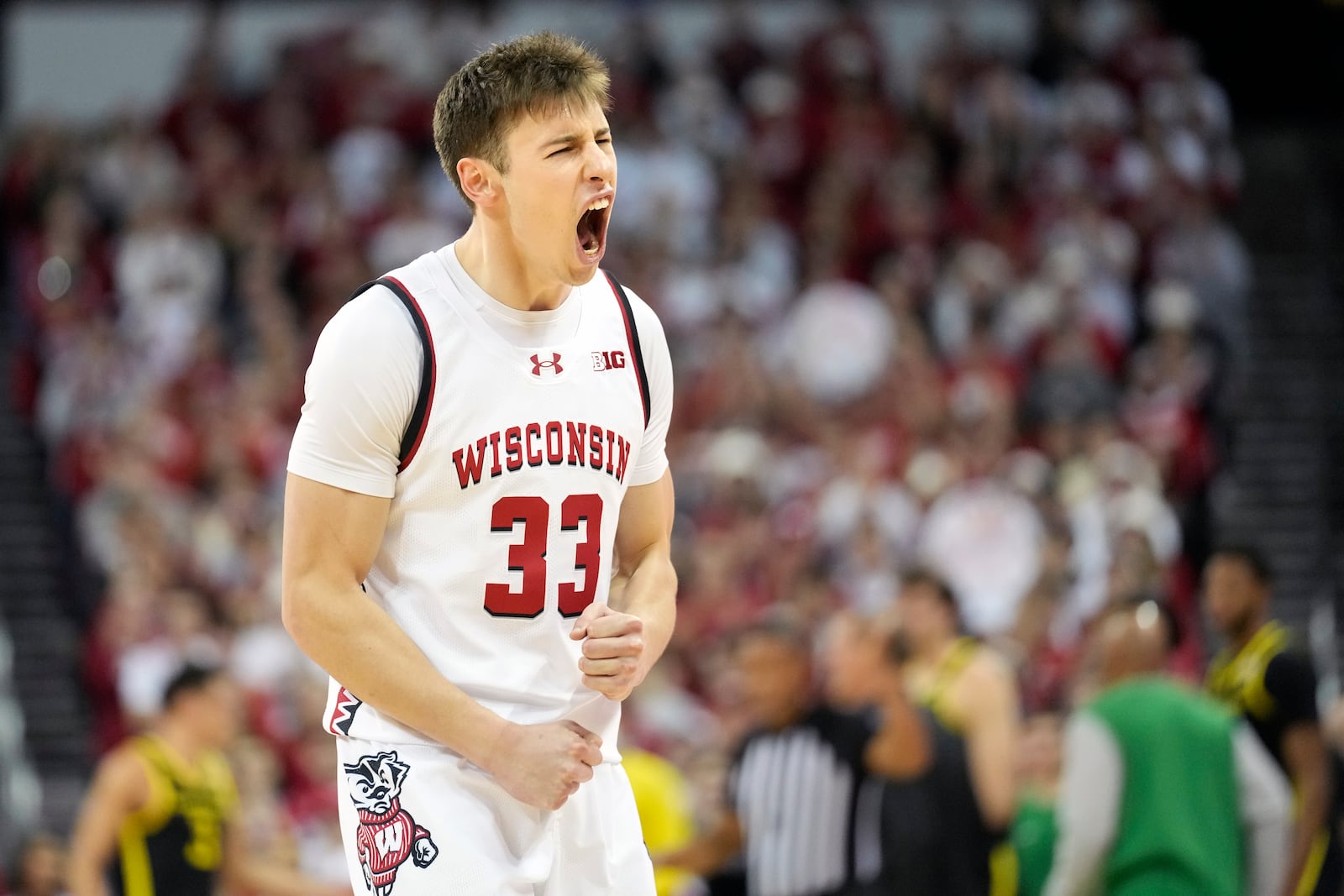 Wisconsin guard Jack Janicki (33) reacts to a dunk scored by Wisconsin guard John Tonje against Oregon during the first half an NCAA college basketball game Saturday, Feb. 22, 2025, in Madison, Wis. (AP Photo/Kayla Wolf)