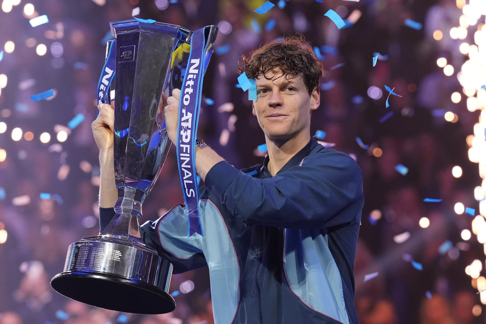 Italy's Jannik Sinner holds the trophy after winning the final match of the ATP World Tour Finals against Taylor Fritz of the United States at the Inalpi Arena, in Turin, Italy, Sunday, Nov. 17, 2024. (AP Photo/Antonio Calanni)