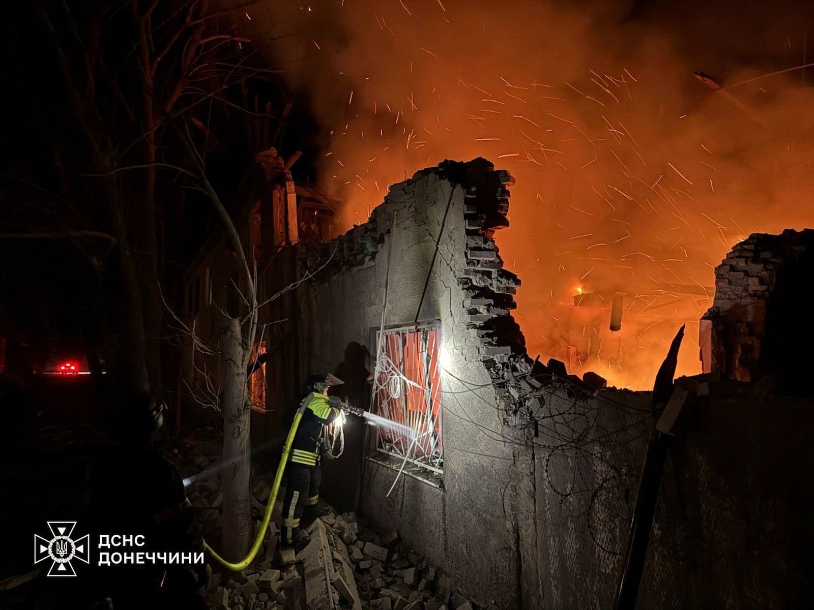 In this photo provided by the Ukrainian Emergency Service, firefighters put out the fire following a Russian attack in Dobropillya, Donetsk region, Ukraine, Thursday, March 20, 2025. (Ukrainian Emergency Service via AP)