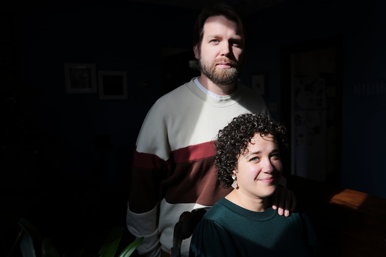 Hannah Jones accompanied by her spouse, Steve Cook, pose for a portrait at home near Philadelphia, Wednesday, March 12, 2025. (AP Photo/Matt Rourke)