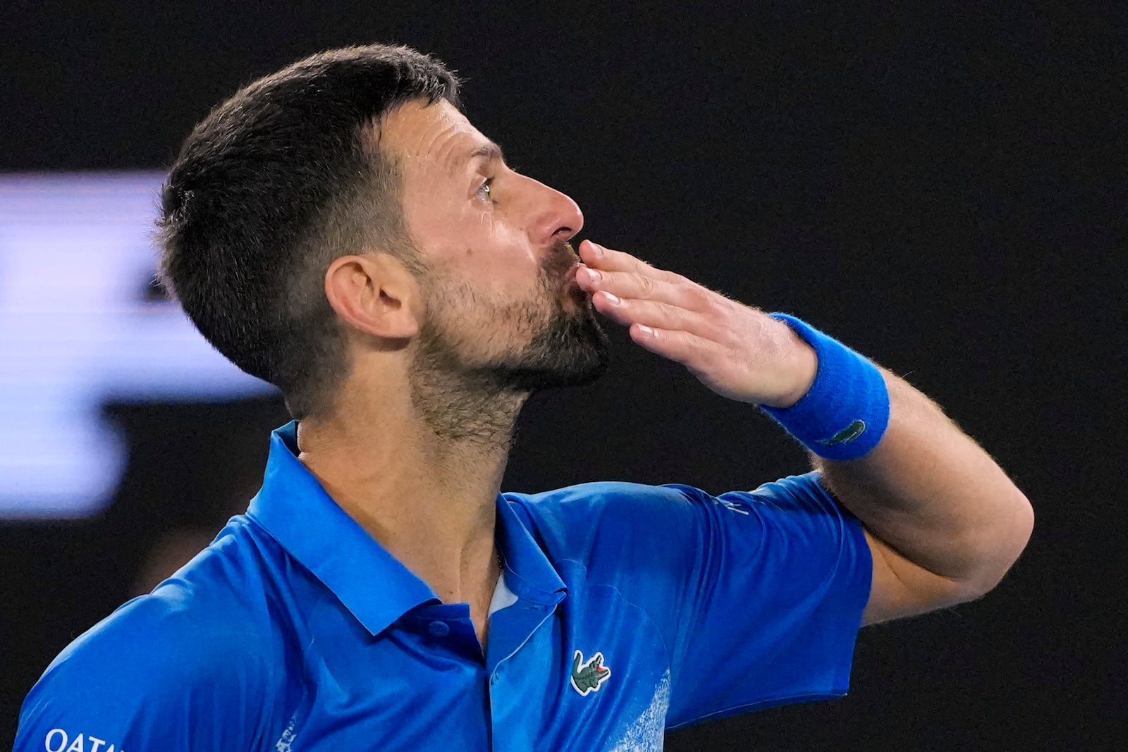 Novak Djokovic of Serbia reacts during his quarterfinal match against Carlos Alcaraz of Spain at the Australian Open tennis championship in Melbourne, Australia, Tuesday, Jan. 21, 2025. (AP Photo/Vincent Thian)