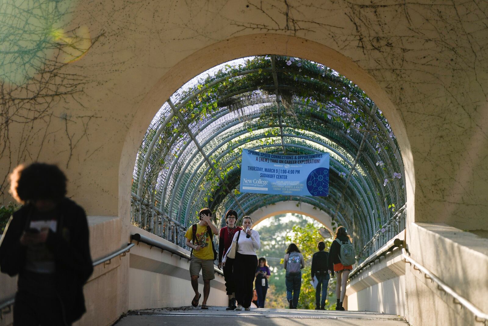 FILE - Students cross a bridge linking different sections of the campus, at New College of Florida, Feb. 28, 2023, in Sarasota, Fla. For years, students have come to this public liberal arts college on the western coast of Florida because they were self-described free thinkers. Now they find themselves caught in the crosshairs of America's culture war. (AP Photo/Rebecca Blackwell)