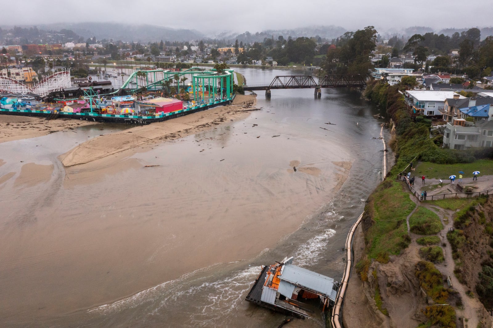 Remnants of a bathroom that fell off the wharf are seen at the mouth of the San Lorenzo River in Santa Cruz, Calif., Tuesday, Dec. 24, 2024. (AP Photo/Nic Coury)