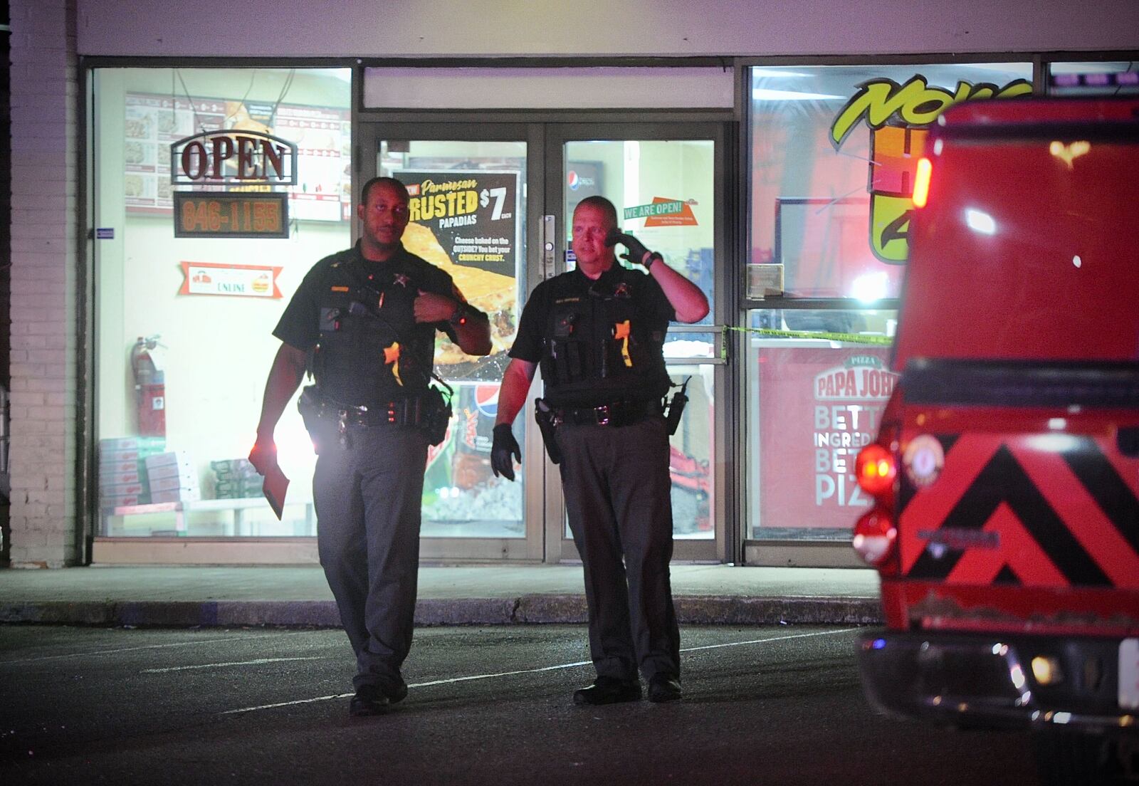 Clark County Sheriff's deputies investigate a shooting in June at Papa John's on Main Street in New Carlisle. Sheriff Deb Burchett is seeking to add more deputies. MARSHALL GORBY/STAFF