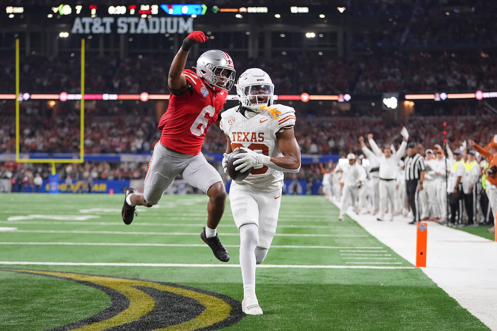 Texas running back Jaydon Blue, foreground, catches a touchdown pass against Ohio State safety Sonny Styles (6) during the first half of the Cotton Bowl College Football Playoff semifinal game, Friday, Jan. 10, 2025, in Arlington, Texas. (AP Photo/Julio Cortez)