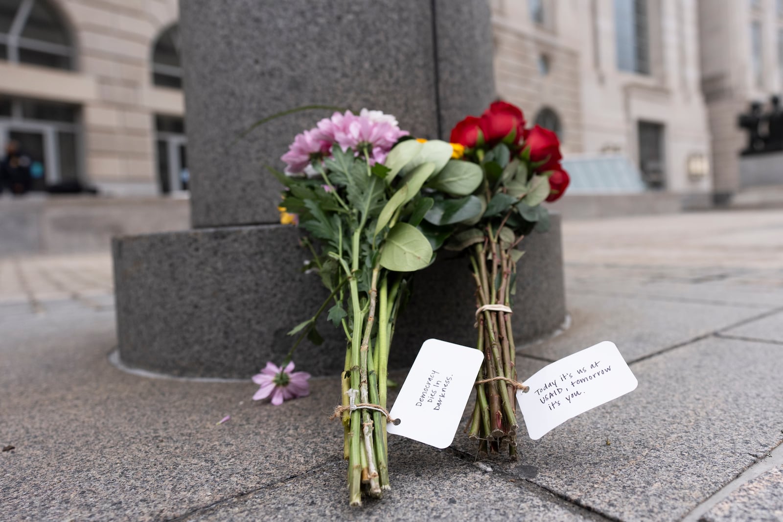 Flowers are left outside the United States Agency for International Development office or USAID office in Washington, Monday, Feb. 3, 2025. (AP Photo/Manuel Balce Ceneta)