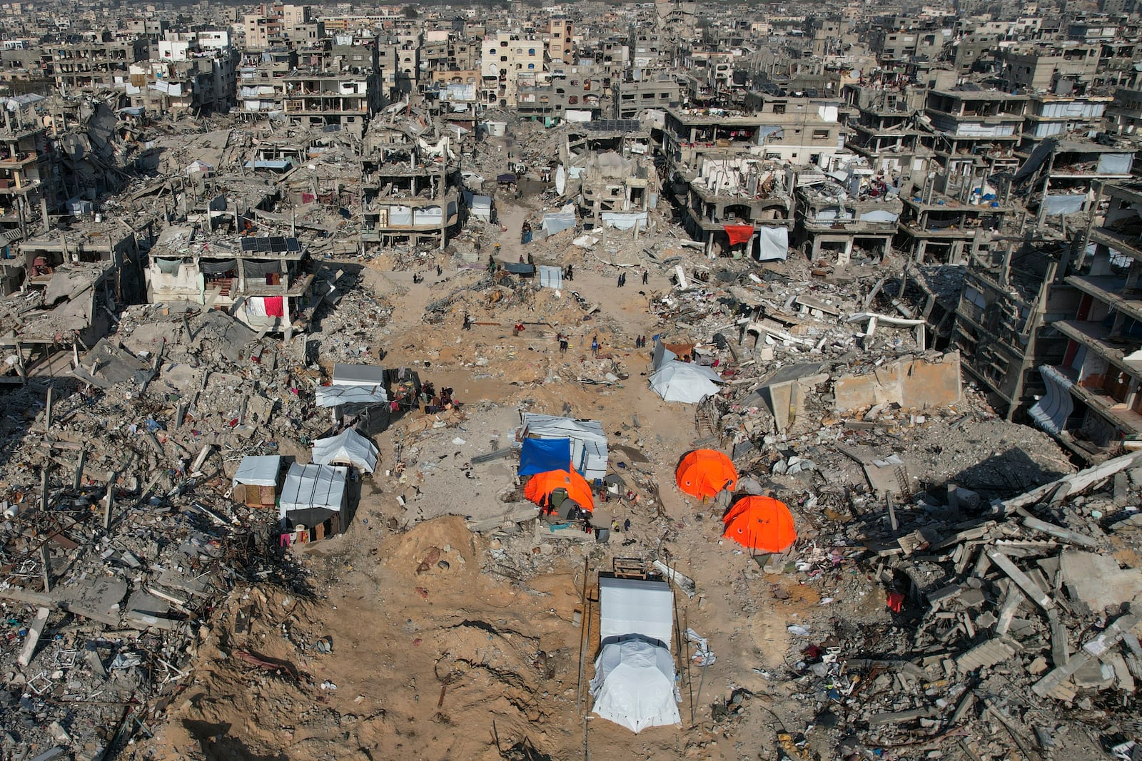 An aerial photograph taken by a drone shows tents amidst the destruction caused by the Israeli air and ground offensive in Beit Lahiya, northern Gaza Strip, on Monday, Feb. 17, 2025. (AP Photo/Mohammad Abu Samra)