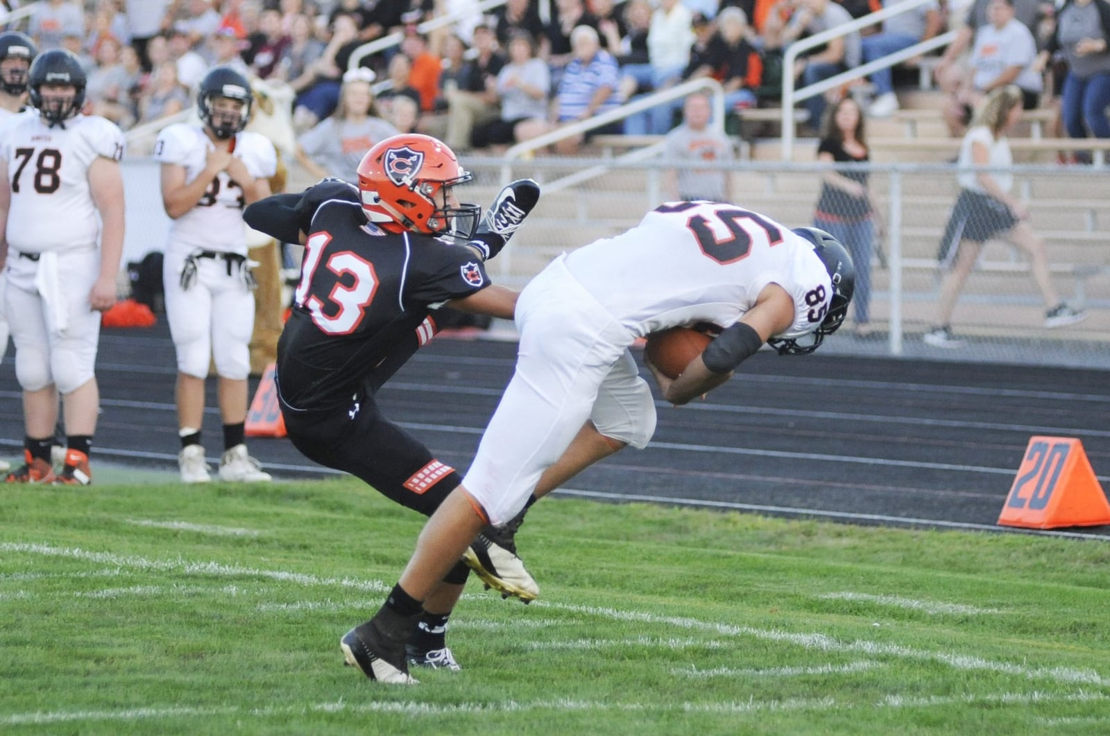 Minster’s Cody Frericks (right) out-wrestles Owen Dorsten of Coldwater to make a long first-half catch. Coldwater defeated visiting Minster 31-20 in a Week 4 high school football game on Friday, Sept. 14, 2018. MARC PENDLETON / STAFF