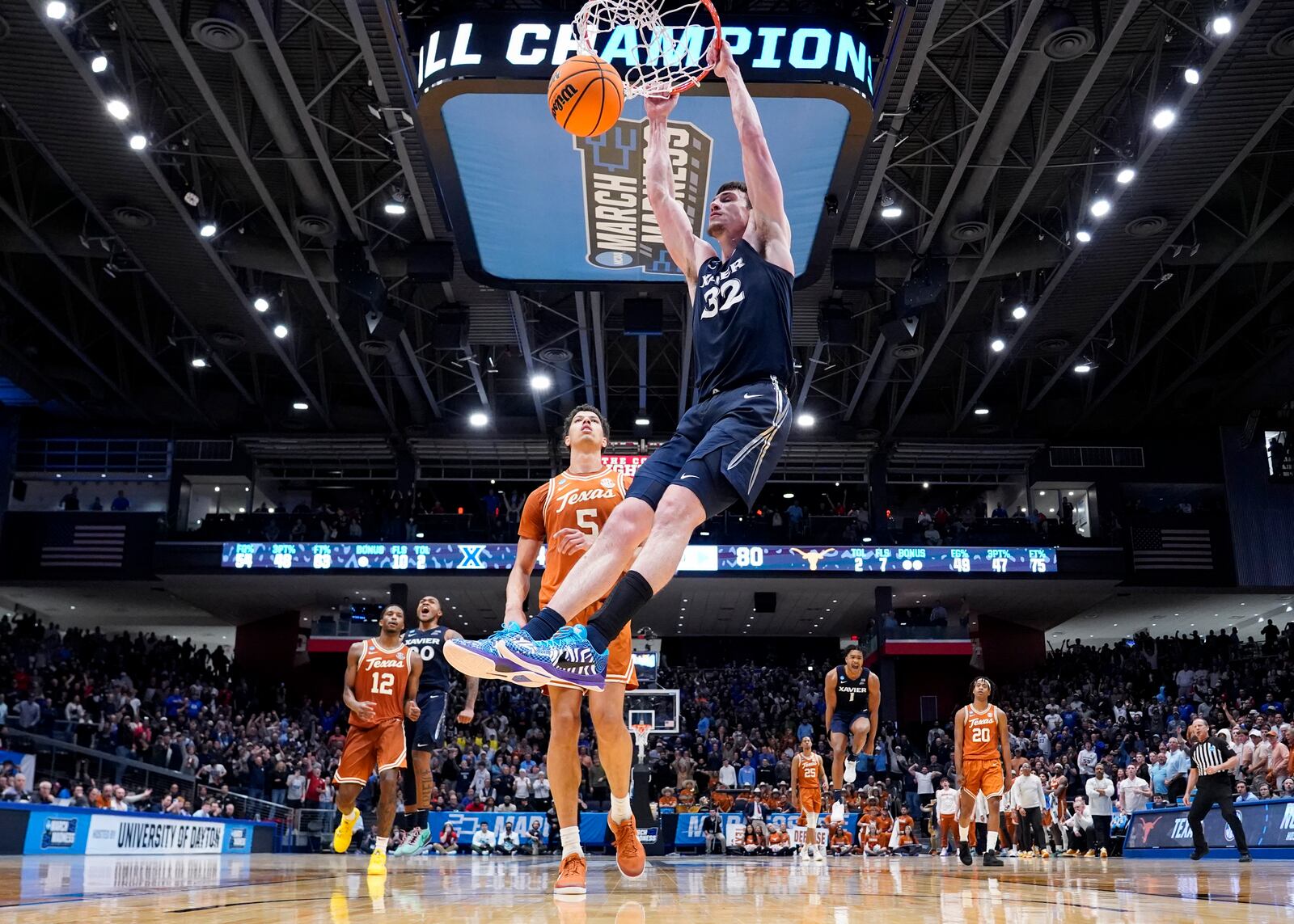 Xavier forward Zach Freemantle (32) dunks against Texas forward Kadin Shedrick (5) during the second half of a First Four college basketball game in the NCAA Tournament, Wednesday, March 19, 2025, in Dayton, Ohio. (AP Photo/Jeff Dean)