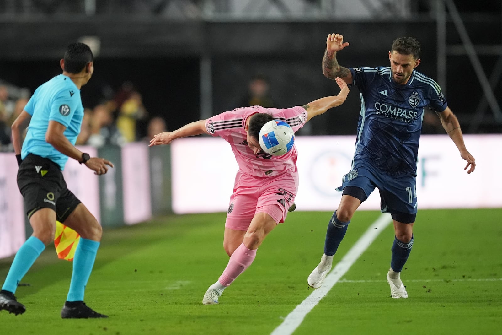 Inter Miami forward Tadeo Allende, left, heads the ball under pressure from Sporting Kansas City defender Tim Leibold (14) during the second half of a CONCACAF Champions Cup soccer match, Tuesday, Feb. 25, 2025, in Fort Lauderdale, Fla. (AP Photo/Rebecca Blackwell)