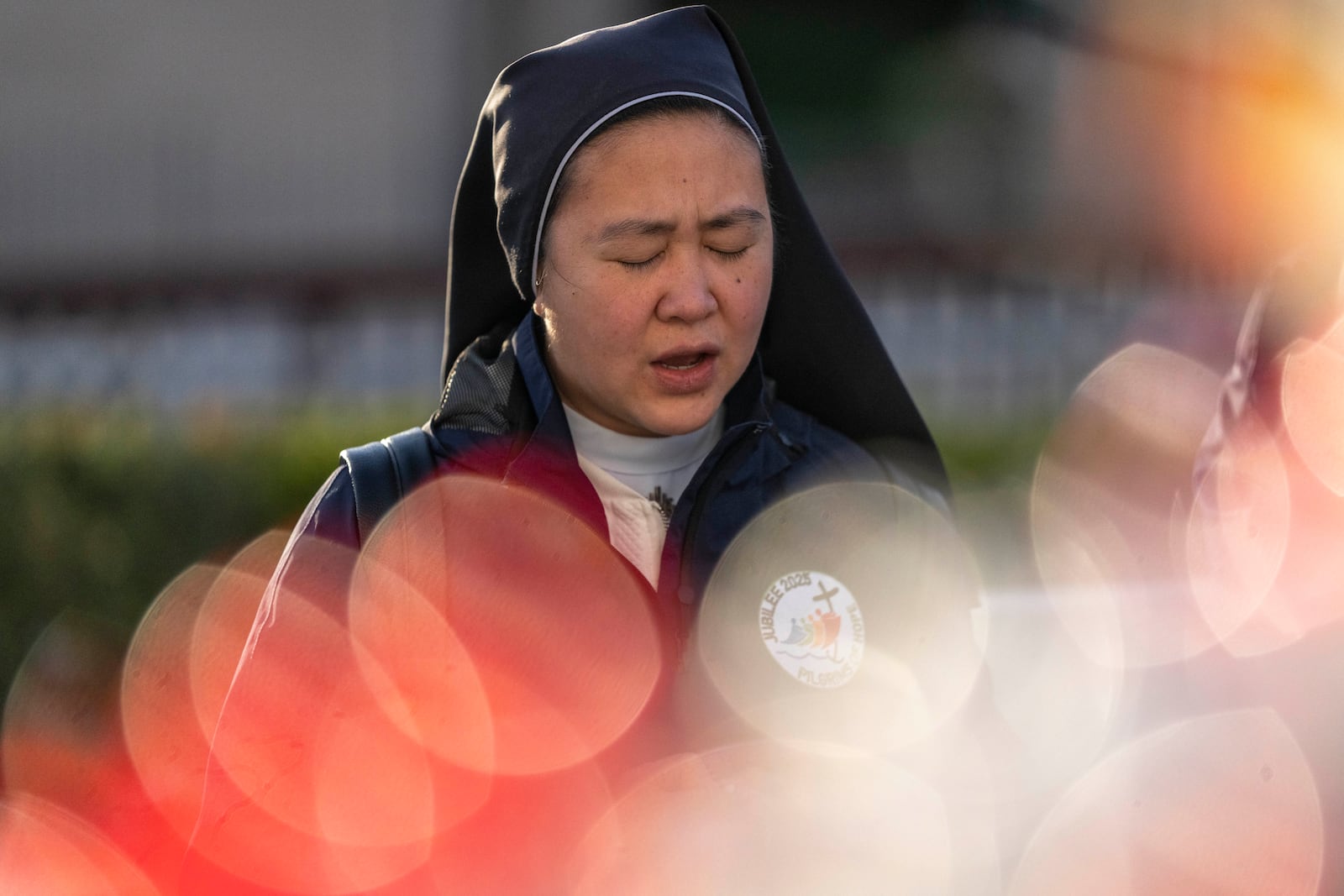 A faithful prays at Agostino Gemelli Polyclinic, in Rome, Friday, Feb. 28, 2025 where Pope Francis has been hospitalized since Friday, Feb. 14. (AP Photo/Mosa'ab Elshamy)