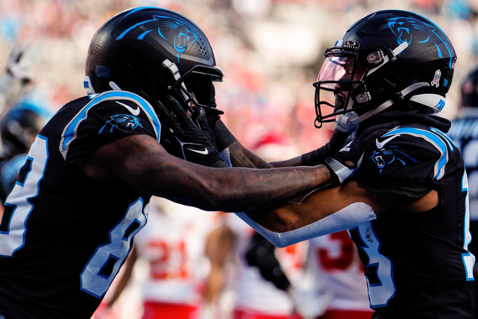 Carolina Panthers wide receiver David Moore, left, celebrates his touchdown against the Kansas City Chiefs during the second half of an NFL football game, Sunday, Nov. 24, 2024, in Charlotte, N.C. (AP Photo/Jacob Kupferman)