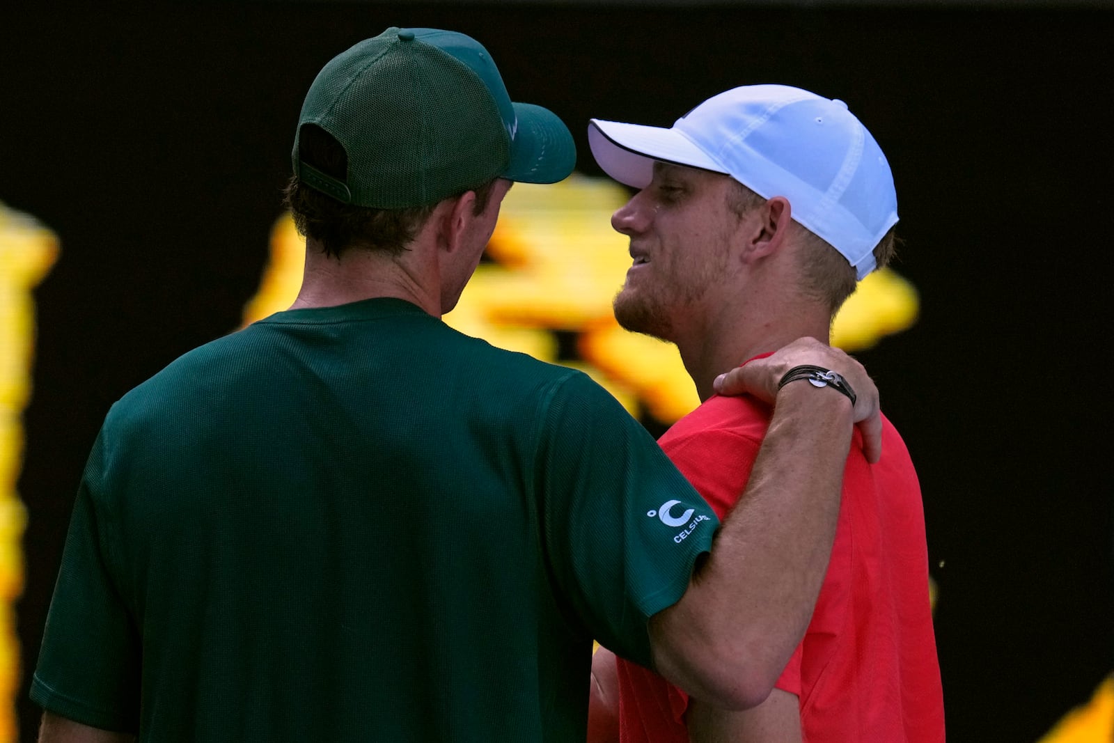 Tommy Paul of the U.S. consoles Alejandro Davidovich Fokina of Spain after a fourth round match at the Australian Open tennis championship in Melbourne, Australia, Sunday, Jan. 19, 2025. (AP Photo/Vincent Thian)