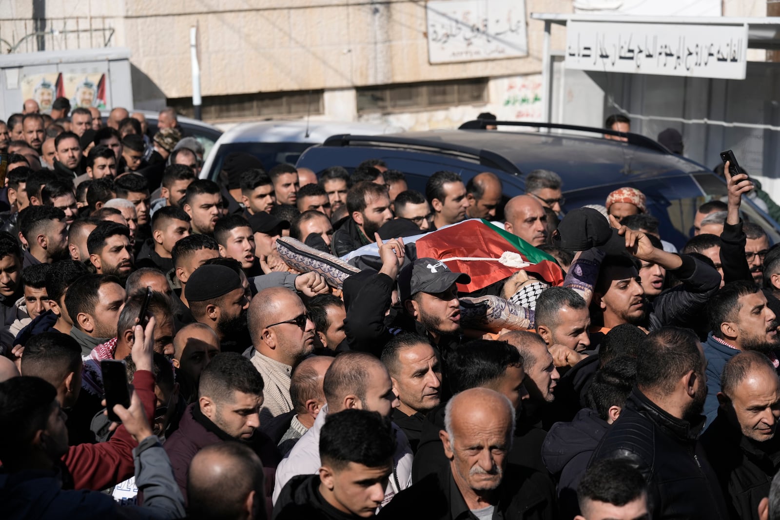 Mourners carry the body of Jaafar Dababsah, a Palestinian Hamas commander killed in a raid by Israeli forces, during his funeral in the village of Talouza, near the West Bank city of Nablus, Tuesday, Jan. 7, 2025. (AP Photo/Majdi Mohammed)