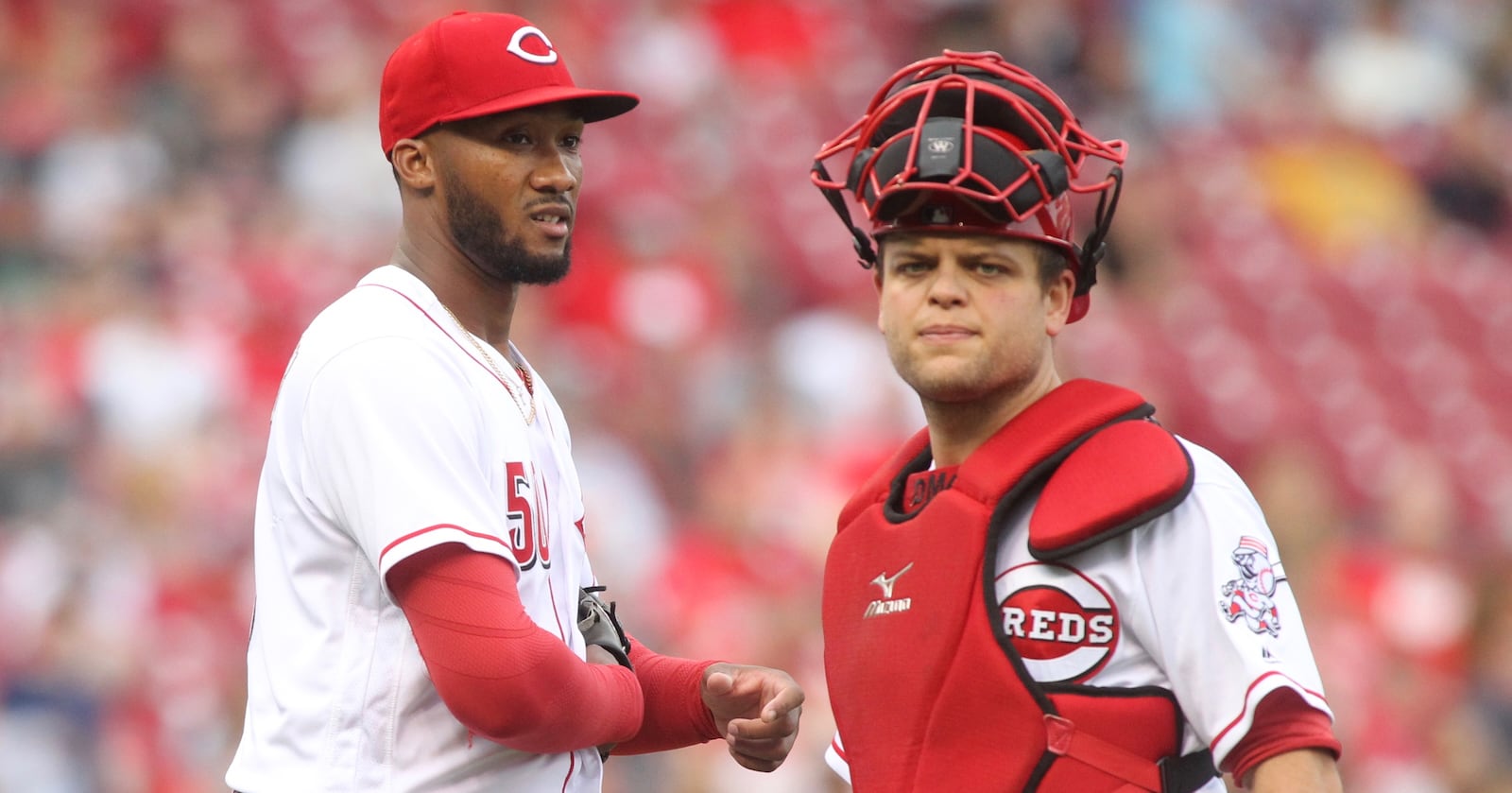 Reds pitcher Amir Garrett and Devin Mesoraco pause after Garrett was hit on the hand by a groundball during a game against Indians on Tuesday, May 23, 2017, at Great American Ball Park in Cincinnati. David Jablonski/Staff