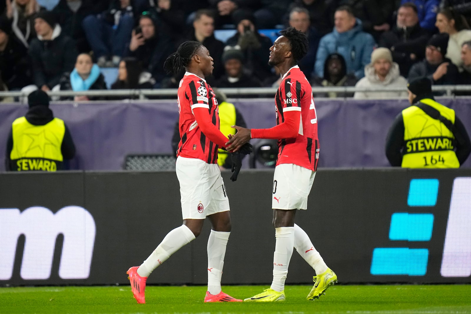 AC Milan's Tammy Abraham, right, celebrates after scoring the third goal against Slovan Bratislava during the Champions League opening phase soccer match between Slovan Bratislava and AC Milan in Bratislava, Slovakia, on Tuesday, Nov. 26, 2024. (AP Photo/Petr David Josek)