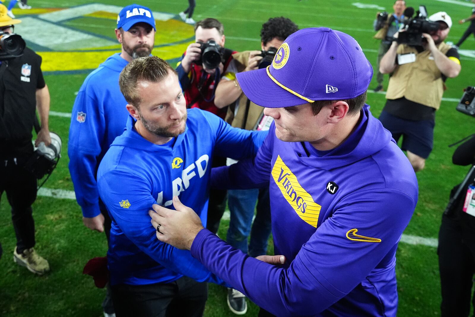 Los Angeles Rams head coach Sean McVay, left, and Minnesota Vikings head coach Kevin O'Connell talk after an NFL wild card playoff football game, Monday, Jan. 13, 2025, in Glendale, Ariz. (AP Photo/Ross D. Franklin)