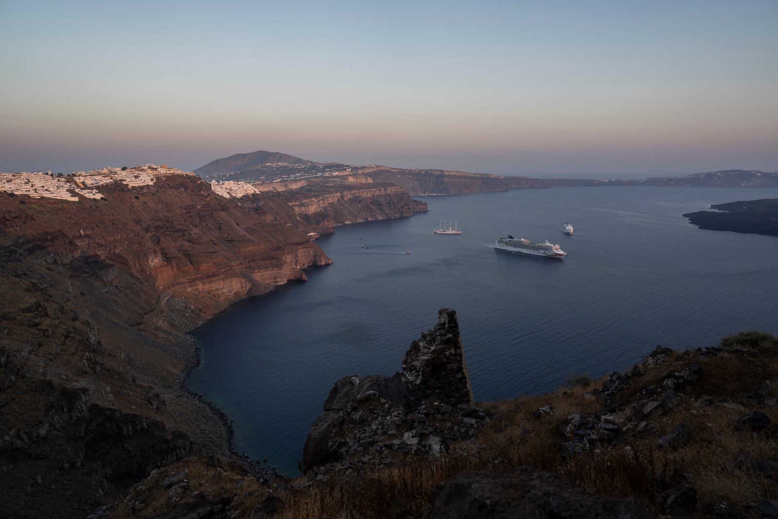 FILE - Ruins of a settlement, including a former Catholic monastery, lie on the rocky promontory of Skaros on the Greek island of Santorini, Wednesday, June 15, 2022. (AP Photo/Petros Giannakouris, File)