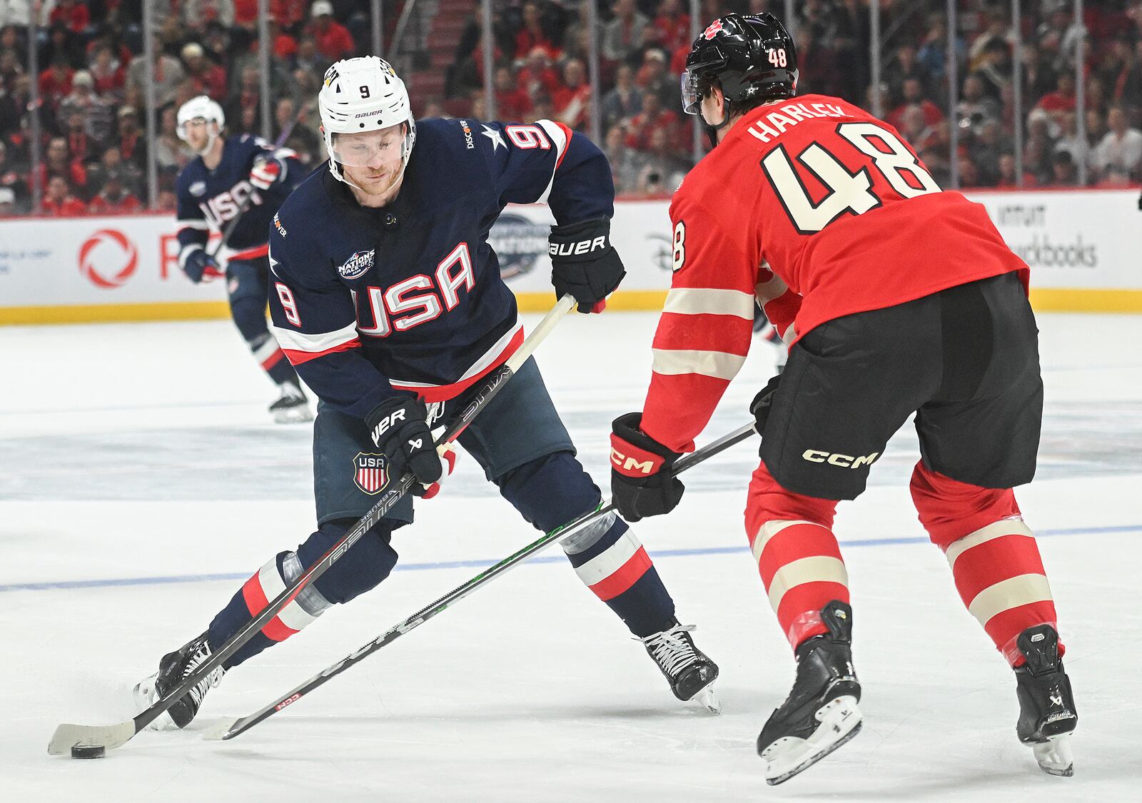 United States' Jack Eichel (9) takes a shot as Canada's Thomas Harley (48) defends during second period 4 Nations Face-Off hockey action in Montreal, Saturday, February 15, 2025. (Christinne Muschi/The Canadian Press via AP)