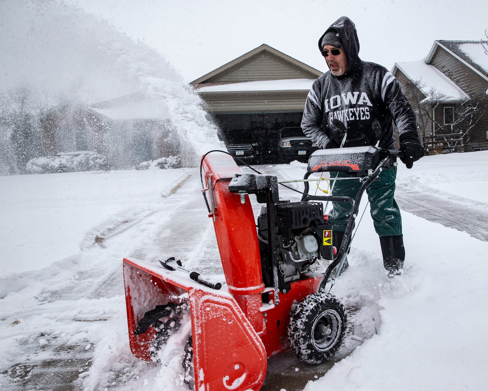 Rick Boland uses a snowblower to clear snow from his driveway in North Liberty, Iowa, Wednesday, Feb. 12, 2025. (Nick Rohlman/The Gazette via AP)