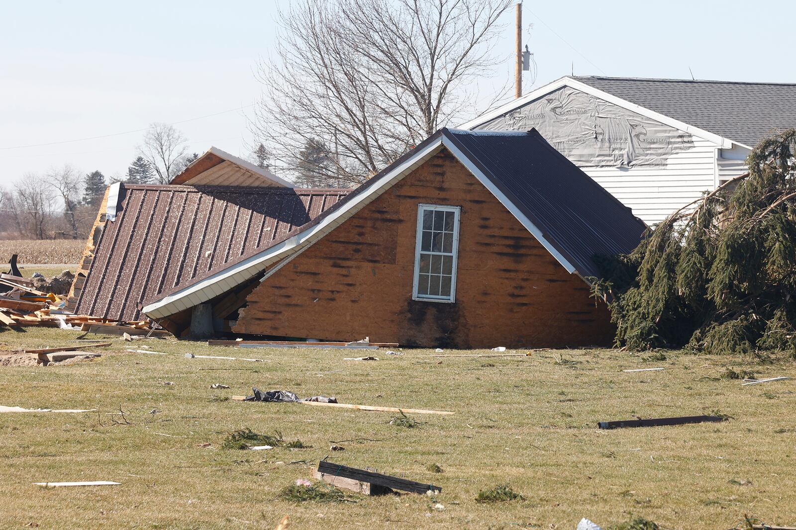 The roof of a garage was picked up in Wednesday's tornado and dropped in a backyard along Mitchell Road. BILL LACKEY/STAFF