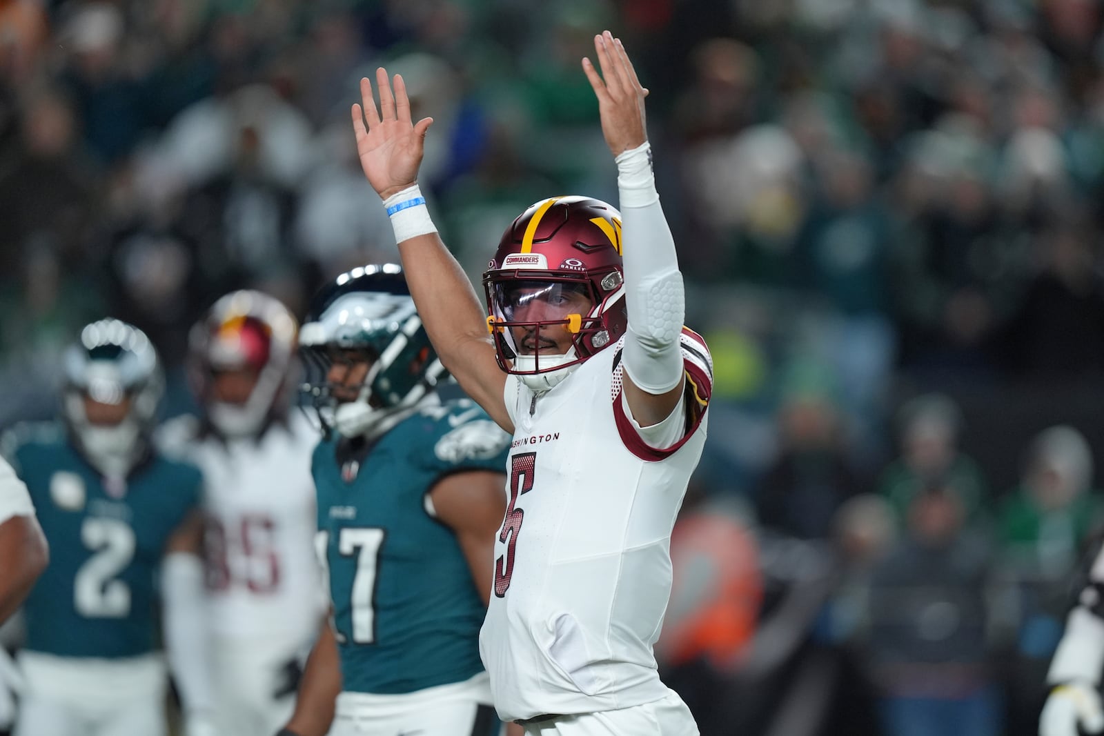 Washington Commanders quarterback Jayden Daniels celebrates a 1-yard touchdown run by Commanders running back Brian Robinson Jr. during the first half of an NFL football game against the Philadelphia Eagles Thursday, Nov. 14, 2024, in Philadelphia. (AP Photo/Chris Szagola)