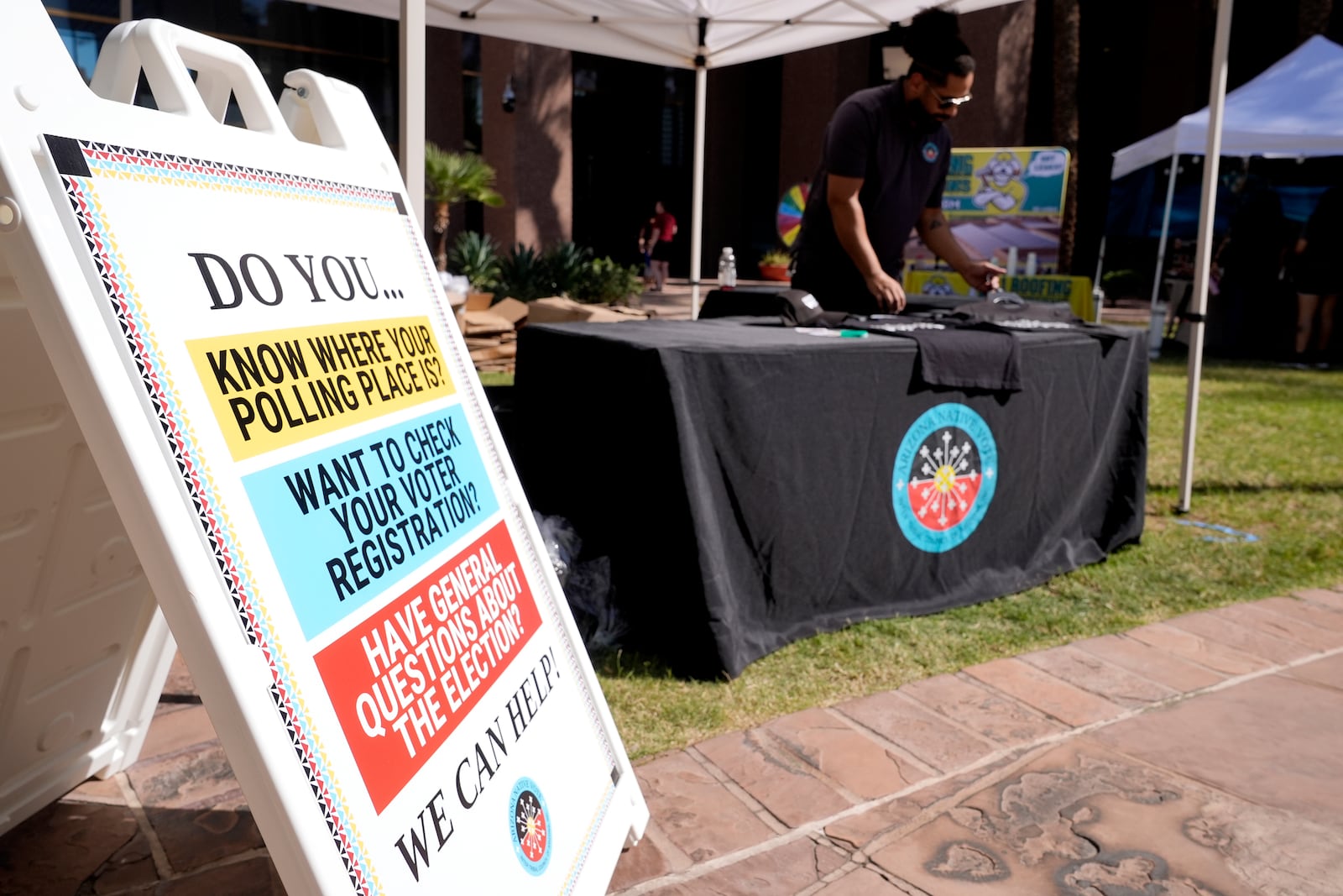 The Inter Tribal Council of Arizona, Inc., has a Arizona Native Vote booth at an Indigenous Peoples' Day event, Monday, Oct. 14, 2024, in Phoenix. (AP Photo/Ross D. Franklin)