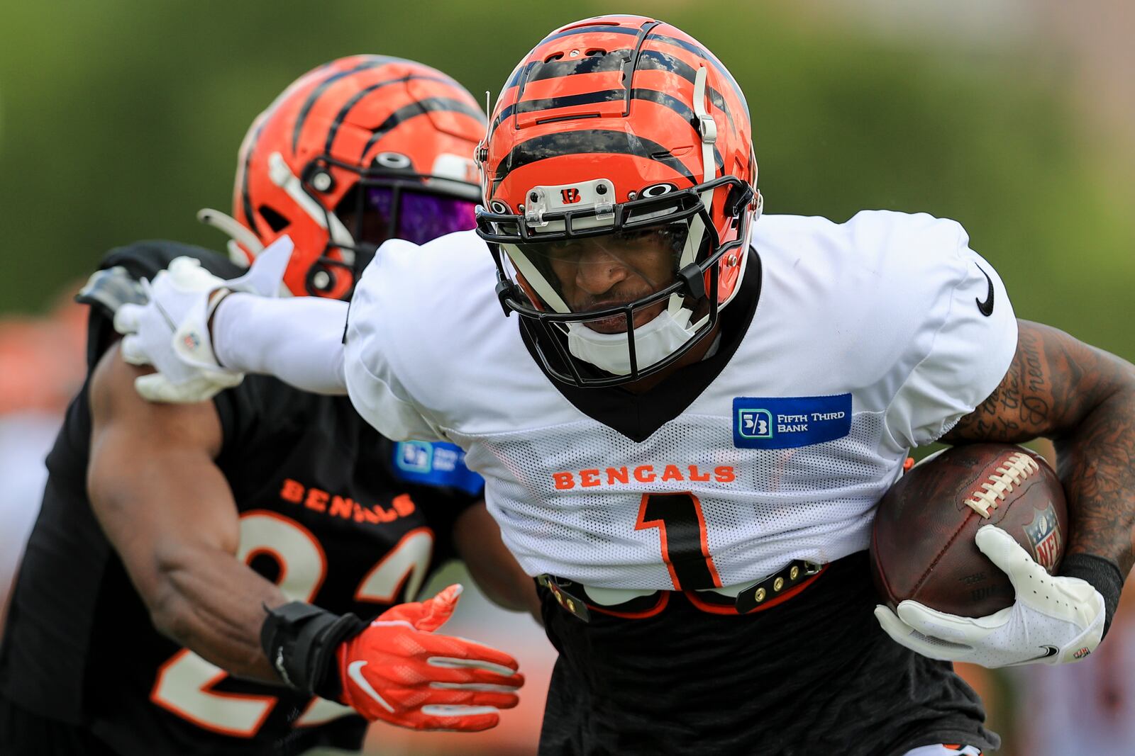 Cincinnati Bengals' Ja'Marr Chase (1) makes a catch against Chidobe Awuzie in a drill during an NFL football practice in Cincinnati, Tuesday, Aug. 3, 2021. (AP Photo/Aaron Doster)