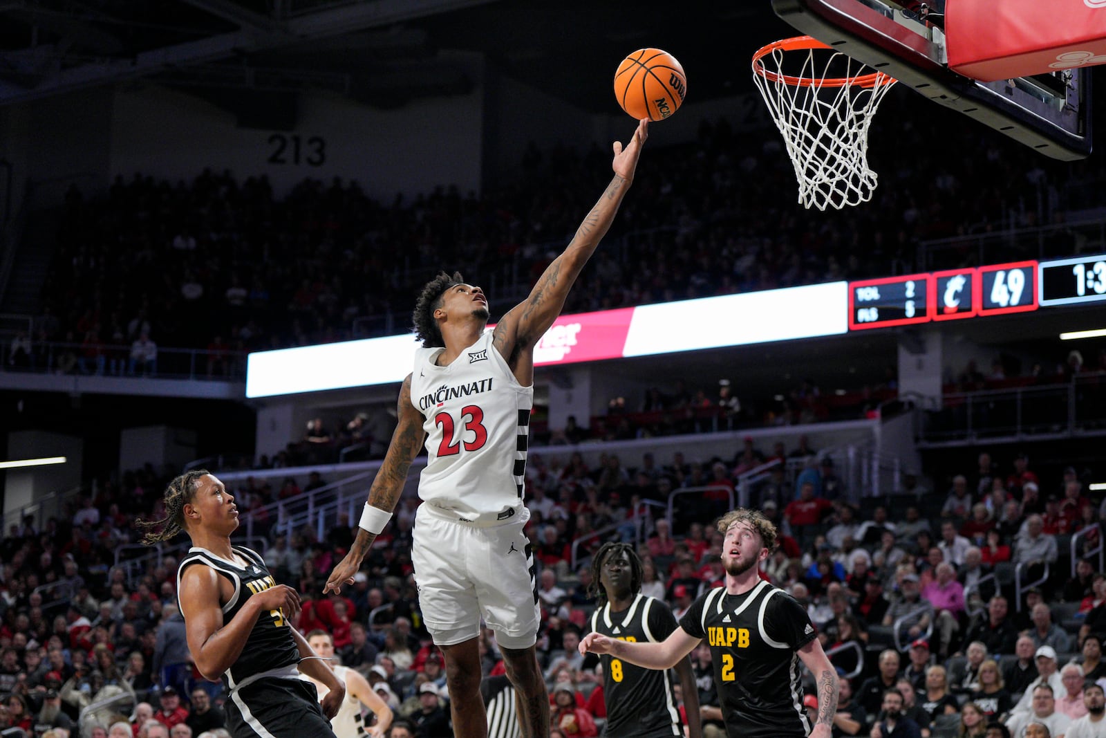 Cincinnati forward Dillon Mitchell (23) shoots during the first half of an NCAA college basketball game against Arkansas-Pine Bluff, Monday, Nov. 4, 2024, in Cincinnati. (AP Photo/Jeff Dean)