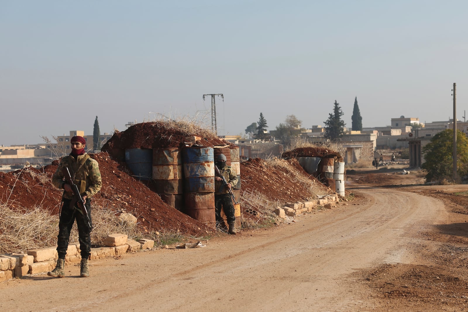 Syrian opposition fighters stand guard in Kafr Halab, Aleppo countryside, Syria, Friday, Nov. 29, 2024. (AP Photo/Ghaith Alsayed)