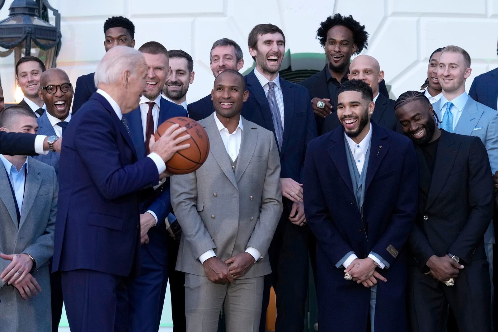 Boston Celtics players react as President Joe Biden holds the ball they presented to him during an event to celebrate the Celtics victory in the 2024 National Basketball Association Championship, on the South Lawn of the White House in Washington, Thursday, Nov. 21, 2024. (AP Photo/Susan Walsh)