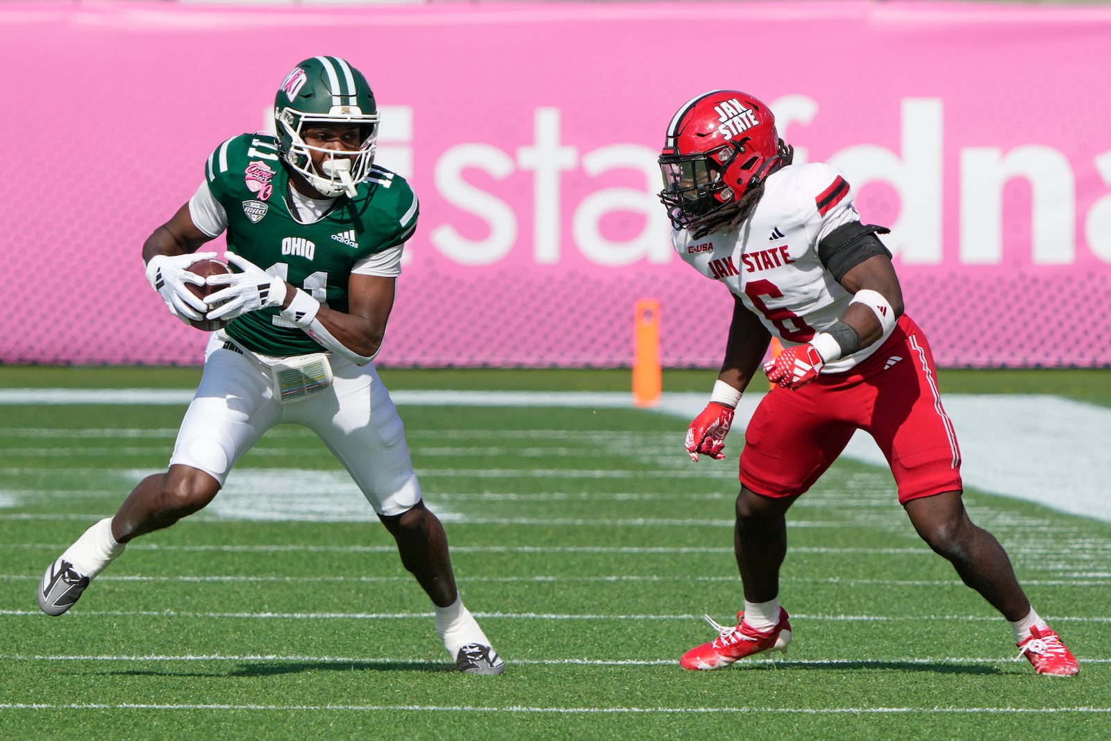 Ohio wide receiver Rodney Harris II (11) looks for a way past Jacksonville State safety Fred Perry, right, after a reception during the first half of the Cure Bowl NCAA college football game, Friday, Dec. 20, 2024, in Orlando, Fla. (AP Photo/John Raoux)