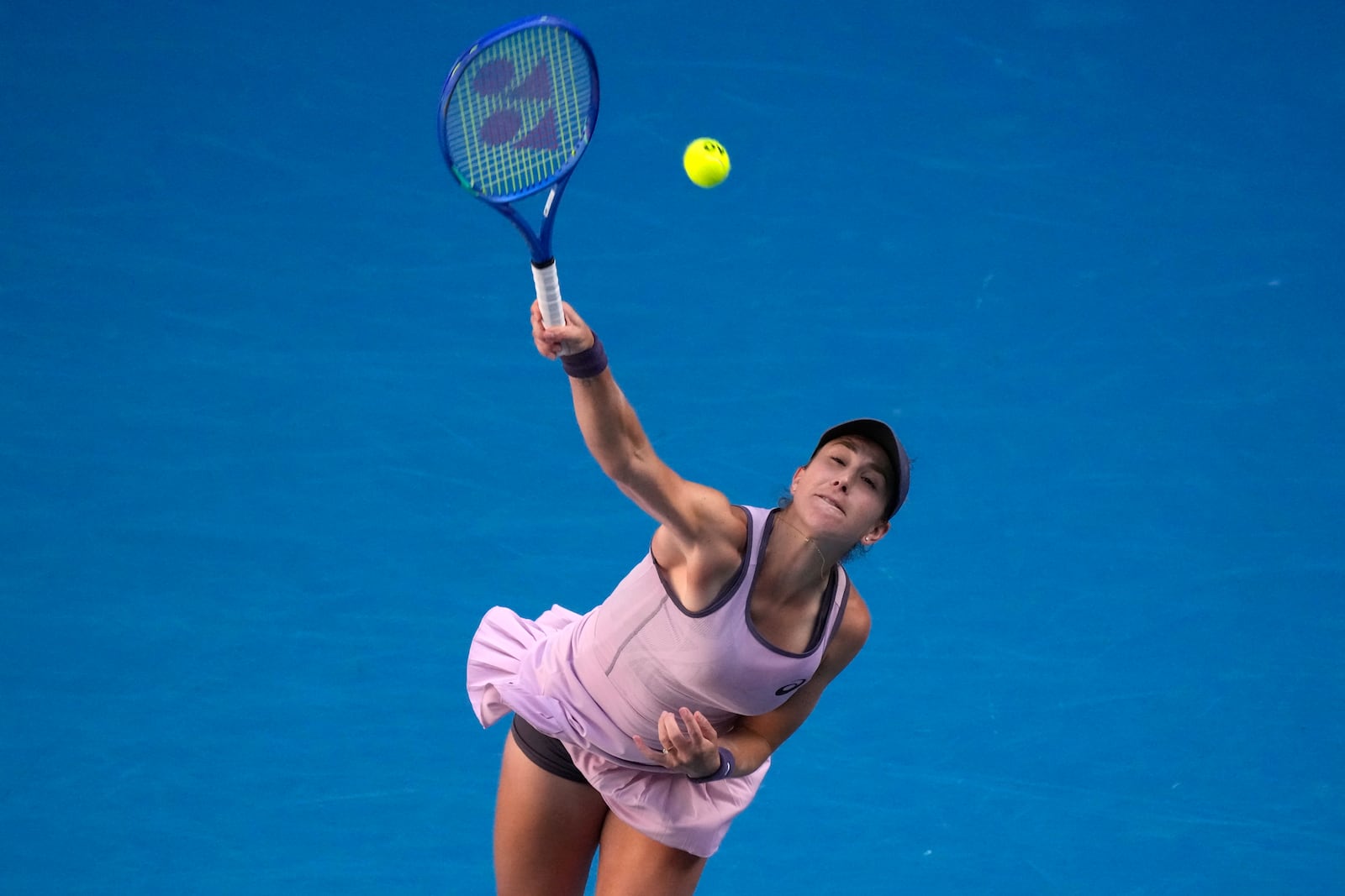 Belinda Bencic of Switzerland serves to Naomi Osaka of Japan during their third round match at the Australian Open tennis championship in Melbourne, Australia, Friday, Jan. 17, 2025. (AP Photo/Manish Swarup)