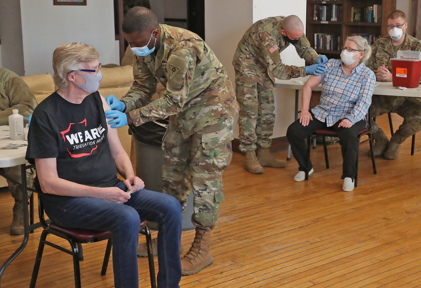 National Guard members give senior residents at Shawnee Place Apartments a COVID vaccine shot Thursday, March 4, 2021, during a clinic set up at the apartments. The clinic is a cooperative effort between the National Guard, the Area Agency on Aging and the Clark County Combined Health District to bring the vaccine to seniors who may not be able to make it to the Clark County clinic at the Upper Valley Mall. BILL LACKEY/STAFF