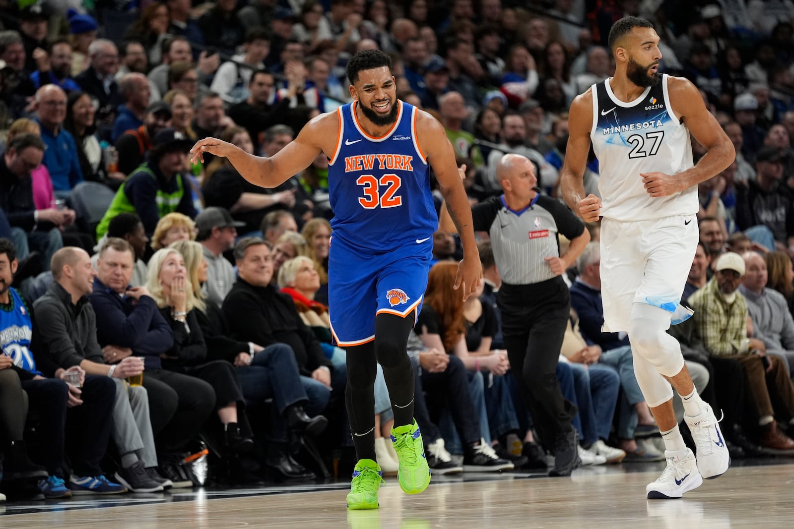 New York Knicks center Karl-Anthony Towns (32) celebrates after making a 3-point basket over Minnesota Timberwolves center Rudy Gobert (27) during the first half of an NBA basketball game, Thursday, Dec. 19, 2024, in Minneapolis. (AP Photo/Abbie Parr)