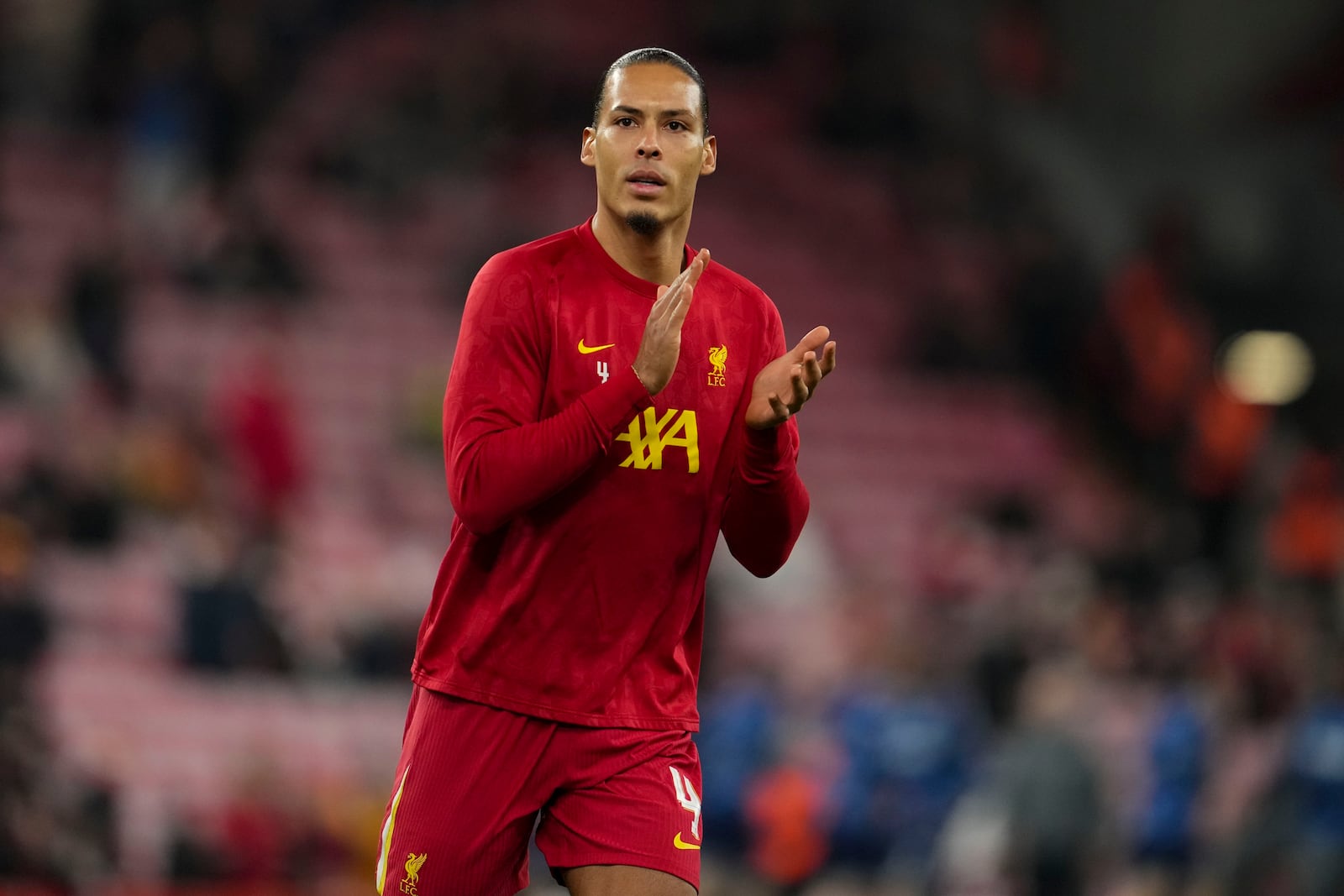 Liverpool's Virgil van Dijk applauds as he warms-up before the English League Cup semifinal second leg soccer match between Liverpool and Tottenham Hotspur at Anfield Stadium in Liverpool, England, Thursday, Feb. 6, 2025. (AP Photo/Jon Super)