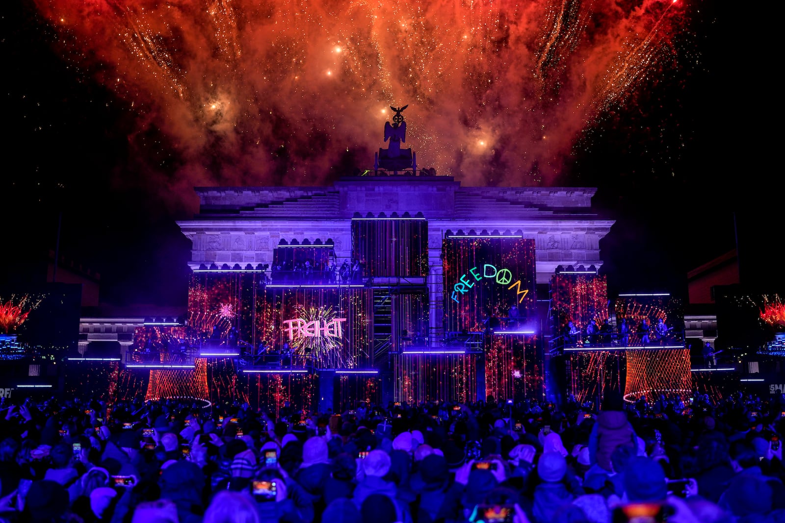 Fireworks light the sky during the as musicians play on stage during the concert for freedom for the 35th anniversary of the fall of the Berlin Wall, in Berlin, Germany, Saturday, Nov. 9, 2024. (AP Photo/Ebrahim Noroozi)